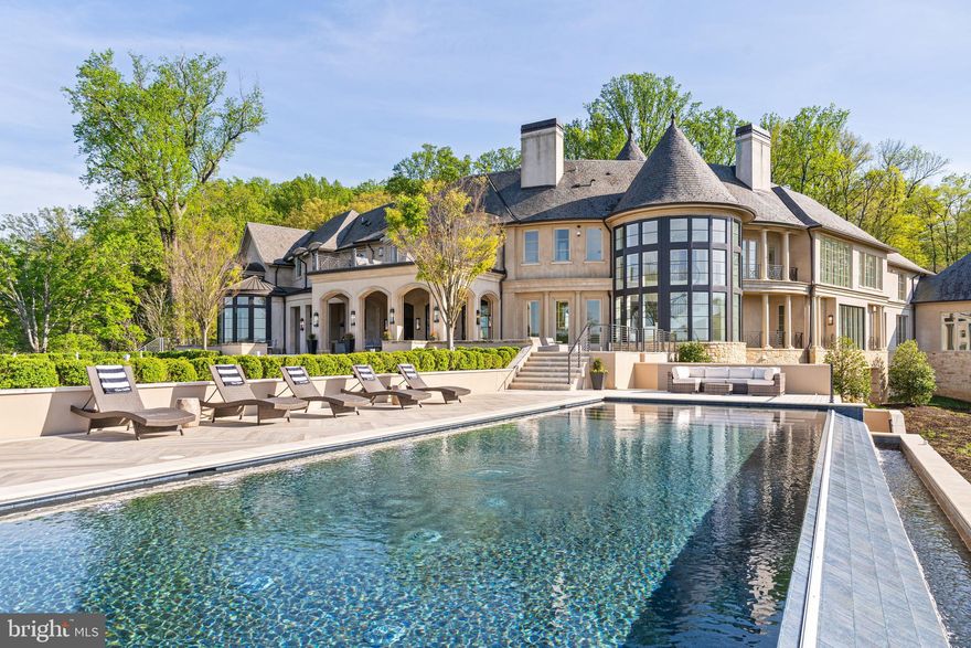 Rugged granite cliffs and panoramic views of the Potomac River set the stage for this exceptional estate which merges extraordinary views with a thoughtfully designed residence, creating an idyllic place to experience a lifestyle of health and well-being. A gated entrance reveals the understated, French Provincial architecture. Native materials including Vermont Slate, copper, and limestone blend seamlessly into the landscape.  A pair of majestic Bald Eagles also call this location home and can often be seen overhead, further emphasizing the unique natural elements found here. All major rooms of the residence feature sweeping views of the river. Custom iron doors introduce guests to a circular rotunda with unobstructed views to the river and beyond. Galleries extend both direction to the public rooms including the main salon, dining room and soaring great room with sweeping views of the river. A world class kitchen by Lobkovitch with design input from renowned chef, Jose Andres, captures every luxurious amenity. A separate catering kitchen will satisfy the most discerning host, and the dining room will easily accommodate 24 guests. On the opposite end of the main level, a spacious salon captures unmatched views of the river and leads to the Collector’s Garage/Sport Pavilion.  This finely finished annex accommodates 18-22 automobiles and doubles as a ballroom space for large indoor gatherings. The Pavilion will also accommodate a multitude of sports and entertainment uses, from pickleball to bowling.  Upstairs, the primary suite with extraordinary river views features a spa-quality, double bath featuring Rohl fixtures, fireplace, coffee bar, and an expansive closet and dressing room. Four additional bedrooms on this level, all with beautifully detailed, en-suite baths, capture stunning views. The lower level introduced by two separate staircases will surprise and delight. A game room adjoins a dramatic wine room with an expansive cellar, wet bar and fireplace. With a quartz crystal backdrop, the cellar accommodates 3,000 bottles. The nearby media room features dual retractable screens. An exercise suite captures sweeping views outdoors and overlooks the indoor basketball court outfitted with official NBA Spaulding hoops, professional flooring, and a separate exterior entrance. Just a few steps beyond, an indoor swimming pool and spa are equipped with an LED lighting system, adjoining bath and shower, and a separate de-humidification system. Two additional bedroom suites complete this level. An ADA compliant elevator services three levels of the residence, and a Smart-House system by Savant controls Lutron lighting, music, HVAC systems, fireplaces, entrance gates, and security systems. A full-house generator, geothermal system for heating and air conditioning, and dual well and septic systems for water and sewer insure self-sustaining operations throughout the estate. Over the daily garage which accommodates four cars, a separate staff suite with a separate entrance provides further accommodations. Outdoors, a covered veranda with built-in heaters, a firepit, and an outdoor kitchen overlook the lawn and gardens. Discrete electronic screens built into the veranda arches provide comfort year around. The central lawn area will easily accommodate a large tent for 200+ guests. Beyond the lawn, an infinity edge pool, multiple terraces and a second firepit provide ideal vantage points for the spectacular views in all directions, abundant wildlife, and the city of Washington beyond. The estate’s ideal location just 10 minutes to Tysons Corner provides easy access to both National and Dulles Airports. Washington is less than 20 minutes. Over eight years in design and construction, The Cliffs captures every imaginable luxury and convenience, further elevating the natural setting and the health and wellness ethos felt throughout. With no peer, The Cliffs is unquestionably the finest new estate residence ever offered in Washington.