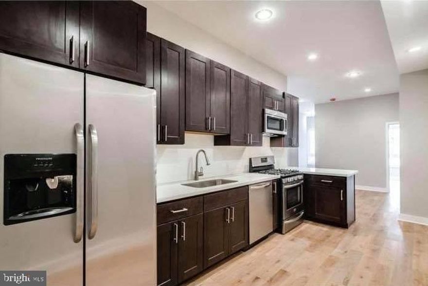 Welcome to this spacious and modern 2-bedroom, 2-bath flat featuring a private balcony and the benefit of a remaining tax abatement. The open-concept layout includes a luxury kitchen with island seating, upgraded stainless steel appliances, quartz countertops, and a subway tile backsplash. The adjoining dining and living areas offer wide-plank hardwood flooring and oversized windows that fill the space with natural light.
A full-sized washer and dryer provide added convenience. Both bedrooms are generously sized with excellent closet space. The bathrooms showcase sleek, contemporary design with Porcelanosa tile and fixtures. The primary suite offers a stunning private bath with an oversized walk-in shower, natural stone accents, and double vanities.
Located just two blocks from Fairmount Avenue and Broad Street, where you’ll enjoy an ever-growing selection of restaurants and cafés. Walk to City Hall, the Comcast Center, and numerous neighborhood amenities. Currently leased month-to-month, this income-producing property is an exceptional opportunity. Schedule your showing today.