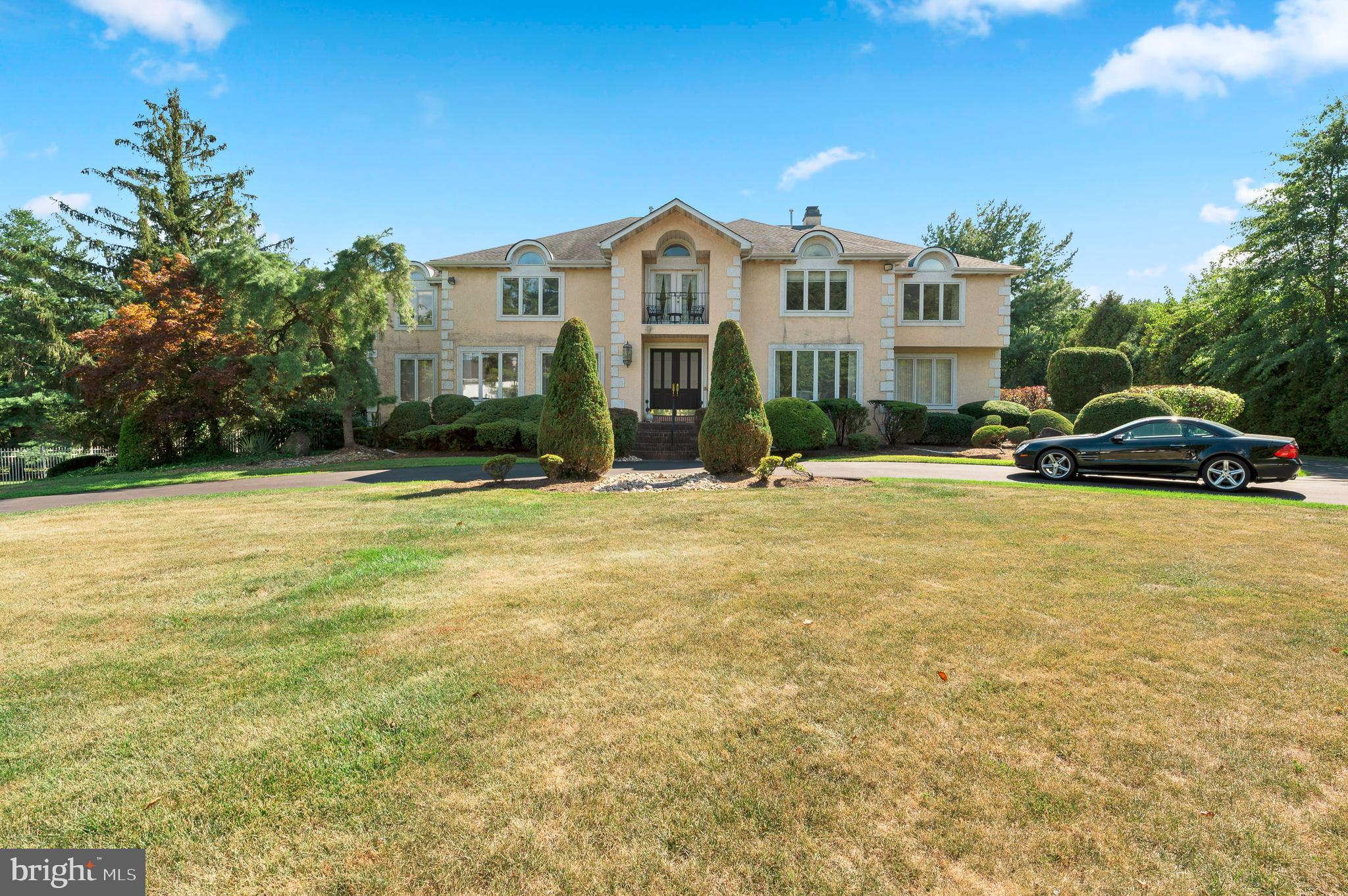 Come fall in love with this magnificent two-story estate home located in the highly desirable Lower Moreland school district. An entertainer’s dream home boasting sweeping indoor and outdoor entertaining spaces while providing serene views with mature landscaping for you and your guests. This stately home has unlimited potential boasting over 6700 sq ft of living space with 6 full bedrooms, 5 full bathrooms and 1 half bathroom, and a full finished basement! 1st floor features include a two-story grand foyer with marble tiles and is flanked on either side with both formal Living and Dining Rooms. Family room and expanded gourmet kitchen with breakfast room and flows seamlessly into the sunroom with windows galore and skylights. Chef’s kitchen features a large island, built-in subzero refrigerator, double wall ovens and plenty of cabinet and countertop space! Sliding door from the inviting sunroom leads to the expansive two-tiered composite deck and pool; perfect for entertaining. This floor also boasts an in-law suite or a guest room and an additional bedroom with an attached bathroom. The formal turned staircase leads to a two-story landing hall where you will find an impressive primary suite boasting 2 walk-in closets, sitting room with electric fireplace, and large marble-tiled bathroom complete with tub and walk-in shower and plenty of storage. Three additional large bedrooms and 2 full bathrooms complete this level. The finished basement with over 3000 sq ft is expansive and includes a wet bar, entertainment space, gym area, and dance floor! This home is completed with an attached three-car garage and 1st floor laundry/mudroom. Also worth mentioning, this property includes a second lot with total acreage of 1.5 acres. Put your personal touches and make this your dream home!