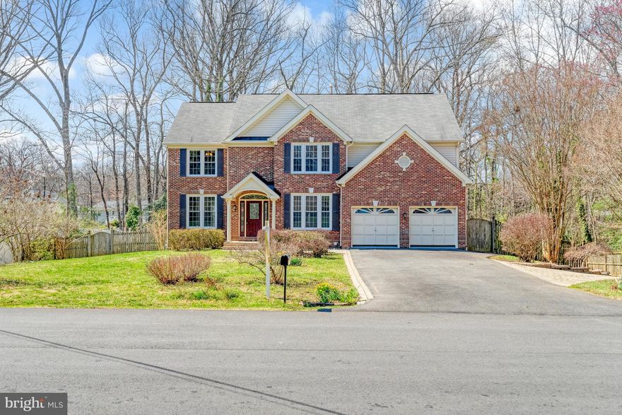 NEW  PRICE!!! This is a home you will love coming home to each day.  It is spacious (4653 finished square feet) with a large kitchen open to the family room with a fireplace and patio door to a huge deck.  There is a formal living and dining room  as well as a library/office on the main level.  Upstairs, there are five nice sized bedrooms. The upper level has  three full baths and a laundry closet with full sized washer and dryer.  The primary bedroom has his and her walk-in closets. and a luxury bathroom. All bedrooms have ceiling fans.  Additional features include:  Updated kitchen countertops; Freshly painted rooms; New carpet throughout,; Lower level in law suite with a fireplace and its own entrance; Laundry room number two in basement; Emergency generator; Built-ins, Two car garage with storage;  Den/media room in basement; Brick front;  Over half acre with terraced side yard and more.   Minutes from the town of Vienna and its amenities. Come see this beautiful, welcoming house and make it your own.