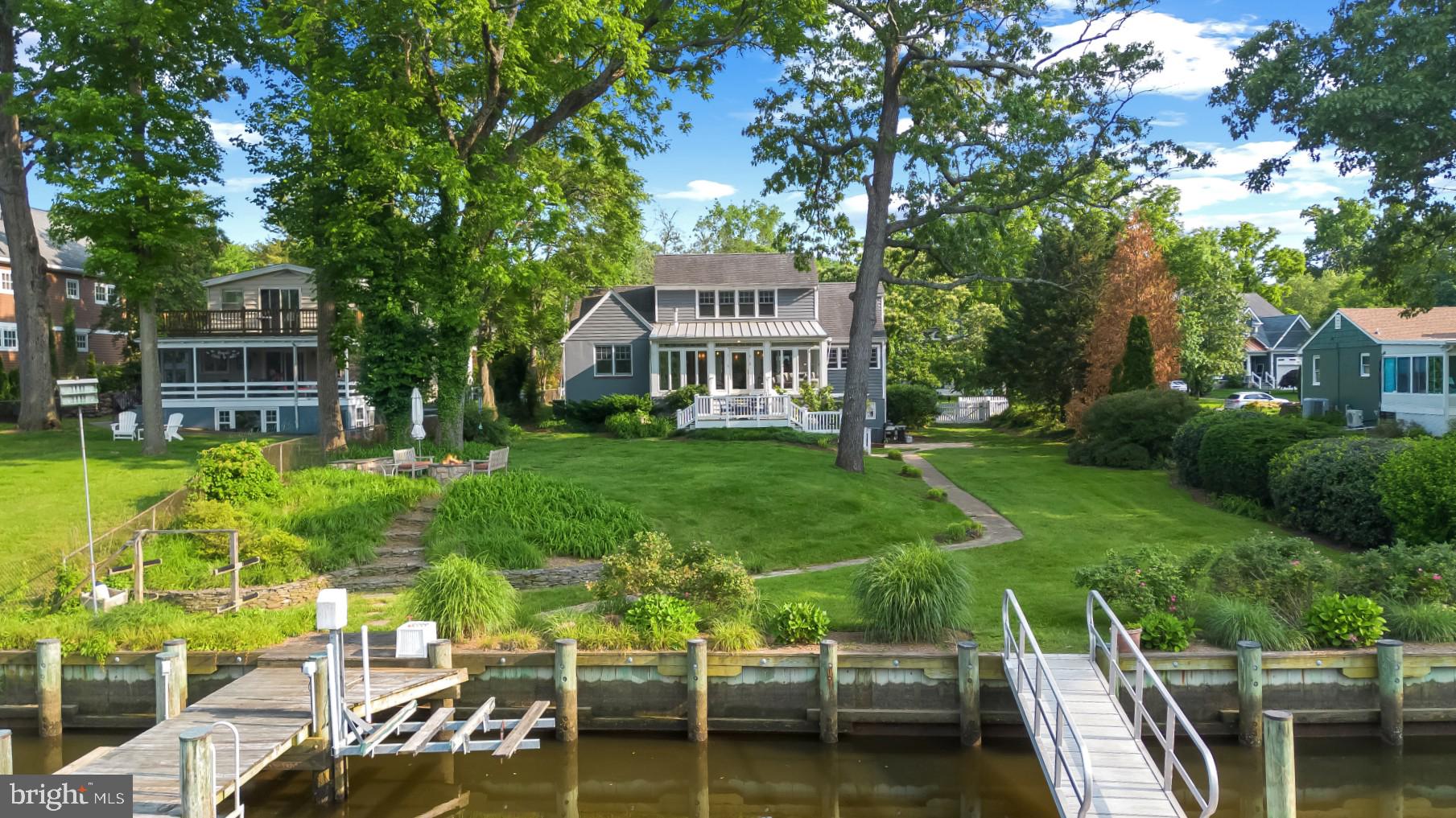 Celebrate the Eastport lifestyle in this captivating Craftsman-style waterfront home located in the Greenacres community. Now is the perfect time of year to enjoy everything the Annapolis/Eastport lifestyle has to offer and this home offers the ideal backdrop for those adventures! With 3 levels of well maintained and impeccable living space, there is plenty of room to entertain family and friends. Enjoy four bedrooms, 3 full baths, tons of natural light, fully- equipped gourmet kitchen, and spacious living room with fireplace. The open concept floor plan maximizes the water views with large windows and glass doors that lead out to the waterside sunroom with gas stove, perfect for relaxing all year round and on a cool summer night. The main level boasts 2 conveniently located and spacious bedrooms with shared hall bath and the bonus room off the living space is perfect for a home office. The Primary suite encompasses the entirety of the upper level and delights with upgrades including built in shelving , walk-in closet and spa-like bath with double vanity, soaking tub and separate shower. The luxuriously sized room overlooks the water and treetops; a perfect place for relaxing and watching the promenade of boats during the summer season and the migratory birds in the fall. The lower level delights with a 2nd living space, direct access to the waterside yard and a 4th bedroom and full bath. The exterior of the home is as much a fairy-tale as the interior with the white picket fencing, gated entry, multiple waterfront patios and beautiful, lush landscaping. When it's time to head out on the water, the private pier is ready to accommodate along with a large custom-made floating dock making it easy to launch your kayak/paddleboards. Enjoy the tranquil waters of Back Creek or head out to the Chesapeake Bay and beyond. As you return from the water and the evening winds down, take in the peaceful surroundings while sitting around the fire pit enjoying the end of a perfect day. This is a great location for a permanent residence or a VRBO/Airbnb vacation rental to generate income all year long. Explore the artful and nautical streets of Eastport/Annapolis to amenities like; five-star restaurants, pubs and street-end parks with hidden treasures. From this location, you are close to some of the Bay's best cruising and fishing areas. Attractive destinations such as Baltimore's Inner Harbor, St. Michael's, Oxford, and Solomon's Island are only a short cruise away. Annapolis offers the perfect balance of small-town charm and big world sophistication. Located just 5 miles to Rt. 50 and 97 which provides direct access to Baltimore, BWI, Ft.Meade/NSA and Washington, DC. Welcome Home!
