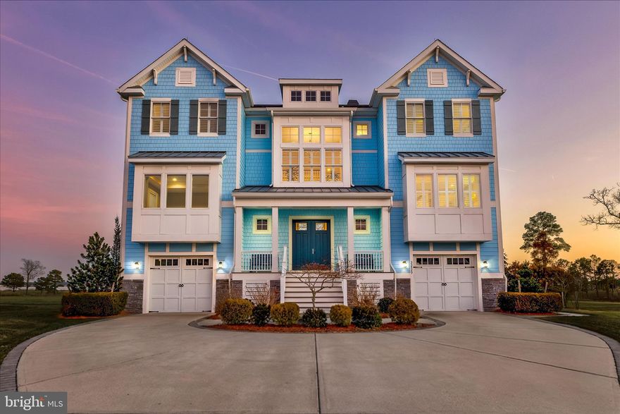 Elevated Bayfront Living in The Peninsula’s Premier Setting

Positioned on a premier bayfront lot with panoramic views of the Indian River Bay, this exceptional five bedroom, five and a half bath coastal contemporary home offers luxury living with thoughtfully curated upgrades throughout. Designed to capture breathtaking water and wetland views, the home blends sophisticated finishes with effortless coastal elegance.

A double door entry welcomes you into a multi-level interior featuring hardwood flooring throughout the main living areas. The main living level showcases a dramatic great room with soaring two-story shiplap ceilings, a floor-to-ceiling gas fireplace with quartz surround, and a stunning wall of windows with remote controlled blinds framing expansive bay and wetland views filled with coastal wildlife.

The gourmet kitchen is designed for entertaining and everyday living, featuring an oversized quartz island, 42-inch soft-close cabinetry, blue glass tile backsplash, gas cooktop, built-in microwave/convection oven, beverage refrigerator, stainless steel appliances, and pendant lighting. The adjoining dining area features wainscoting and sliding doors leading to a screened porch, creating seamless indoor-outdoor living. This level also includes a private office with built-in window seating and granite topped storage, a powder room, and the luxurious primary suite.

The primary bedroom retreat offers a tray ceiling with ambient lighting, private balcony access, dual walk-in closets, and a spa-inspired bath with freestanding soaking tub, oversized tiled glass shower, dual vanities, plantation shutters, and a private water closet.

The lower level provides access to two separate garages, a mudroom with built-in storage, a recreation room with wet bar featuring concealed refrigerator and wine storage, a bonus room with atrium pocket doors ideal for fitness or hobbies, and a guest bedroom with Jack-and-Jill bath. Sliding doors lead to the hardscaped terrace featuring a porch swing, grilling station, and multiple areas for outdoor dining and relaxation overlooking the golf course, wetlands, and bay.

Upstairs features a loft with balcony access and three spacious bedrooms, each with private en suite baths and walk-in closets. One bedroom includes its own private balcony with bay views. Elevator access services all levels for added convenience.

Beyond the residence, The Peninsula on the Indian River Bay delivers a dramatically refined resort lifestyle across 800 acres of spectacular coastal landscape. Anchored by a Jack Nicklaus Signature Golf Course, the community offers world-class amenities including fine and casual dining at the Terrace Grille, elegant clubhouse gathering spaces, golf lounges, billiards, and a pro shop.

Wellness and recreation opportunities are equally impressive, featuring a full-service spa, state-of-the-art fitness center, professional tennis and pickleball facilities, basketball courts, and indoor and outdoor aquatic complexes. Residents enjoy an adult-only heated pool, wave pool with sandy beach entry, and expansive sun decks designed for relaxation and social gatherings.

Outdoor enthusiasts will appreciate scenic boardwalk trails, a nature center along Lingo Creek, a private bay beach and fishing pier, dog park, and miniature golf. Ideally located near historic Lewes and the vibrant Rehoboth Beach boardwalk, The Peninsula offers an extraordinary balance of luxury, recreation, and coastal charm. This remarkable bayfront retreat presents a rare opportunity to experience elevated coastal living at its absolute finest.