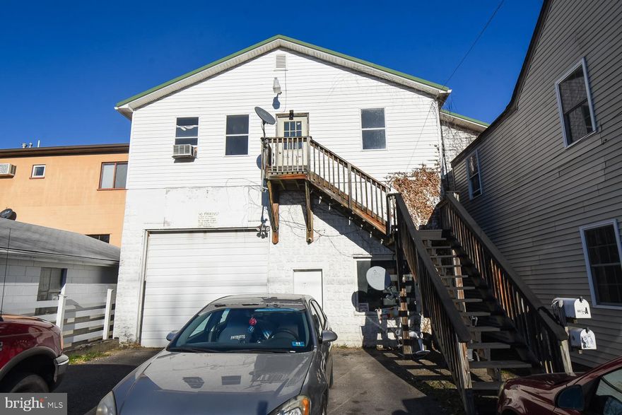 Amazing space ready for you to move in. 2 garage spaces and 2 apartments above are ready for you to rent or tear down the walls and make a single unit. Great off-street parking and readily available to everything that Keyser has to offer.