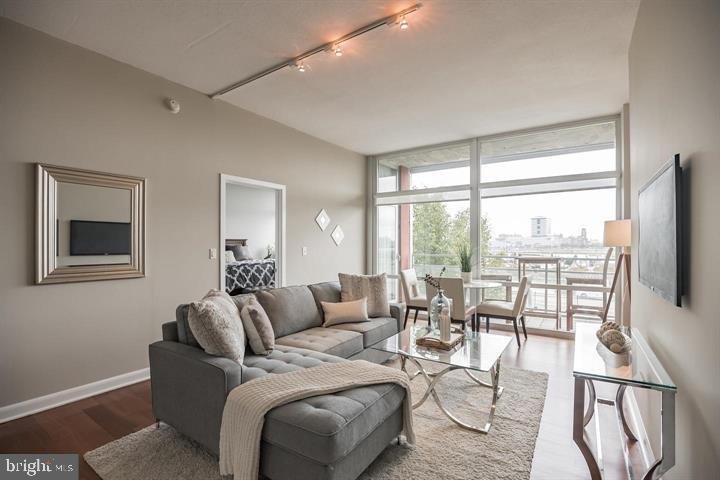 Welcome to the Residence at 22 S Front. Introducing unit 207 – An exemplary and spacious 2-bedroom, 2-bathroom, designer corner unit encompassing 1362 sq. ft with a fabulous functional layout, sizable living room, cook’s kitchen, generously sized bedrooms on opposite sides for optimal privacy, spa-like baths, hardwood floors throughout, private balcony, and numerous floor-to-ceiling windows providing courtyard and river views. Upon entering this immaculate unit, you are greeted by an expansive gallery-like foyer area with walls of windows overlooking the beautifully landscaped courtyard, featuring brick walkways and abundant greenery. The elegant foyer leads to a stunning and light-filled open-concept living/dining/kitchen area, adorned with exquisite Brazilian hardwood floors, high ceilings and floor-to-ceiling windows offering scenic views including the river and bridge. The cook’s kitchen boasts 42-inch cabinetry, handsome granite countertops including a large breakfast island and upgraded stainless steel appliances, including a 6-burner stove. Adjacent to the main living area is an expansive private master suite with wonderful eastern exposure and direct access to your own private balcony with spectacular views. The master suite features a sizable full spa bath with a 60-inch granite double vanity, frameless glass walk-in shower, and porcelain floors. A huge walk-in California closet with numerous built-ins plus an additional custom closet. On the opposite side of the master bedroom is a wonderful guest bedroom/work-from-home office with hardwood floors, ample closet space and additional courtyard views, plus another hall guest bath and separate laundry room with new washer & dryer. About the building: Discover the Residence at 22 S Front, 17 years young. A meticulously maintained building featuring a welcoming lobby with a doorman, landscaped courtyard, and a stunning roof deck providing breathtaking panoramic views. Experience effortless living in this magnificent and rarely offered corner unit in a beautiful boutique building in historic Old City Philadelphia. Schedule your appointment today.