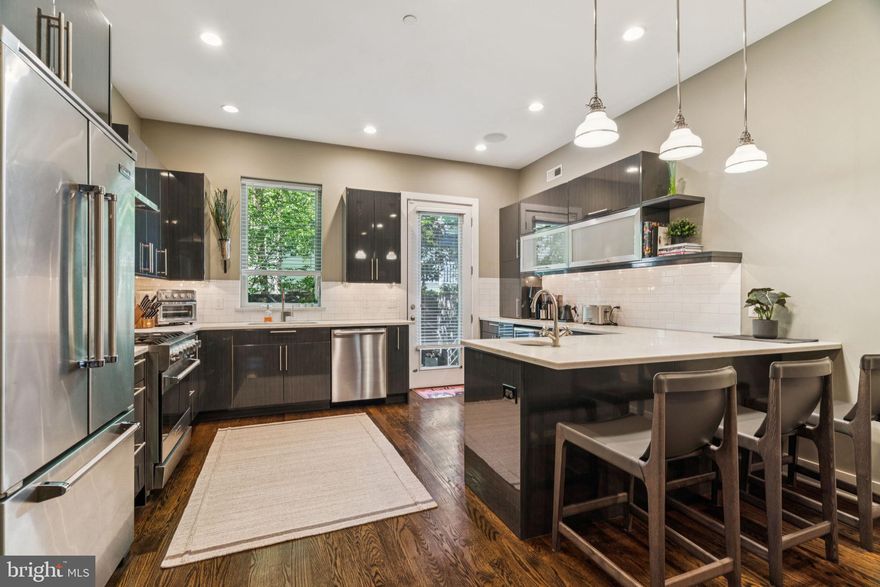 Discover this stunning and elegant 4 bedroom, 4 bathroom home featuring custom finishes and one of a kind outdoor spaces. There is a large and beautifully finished lower level which boasts impressive 11-foot ceilings. You'll also appreciate the convenience of a 2-car garage with a NYC-style lift, accommodating both an SUV and a sedan.

Step outside to enjoy a delightful, private rear patio along with one of the city’s most remarkable rooftop decks, complete with multiple inviting seating areas that offer breathtaking skyline views and exceptional privacy. Inside, the residence showcases high ceilings, hardwood flooring and exquisite, custom finishes including professional built-in speakers and solid-core doors throughout.

The chef’s kitchen is equipped with Viking appliances, ample designer cabinetry, and quartz countertops with eating and coffee bars. The spacious primary suite on the second floor includes a private balcony, a trey ceiling with ambient lighting, and a large custom walk-in closet, alongside numerous thoughtful enhancements.

The lower level features two finished spaces along with a full bath, offering the possibility of a legal 5th bedroom. The rear patio is a true gem. While the rooftop deck, complete with a wet bar, presents one of the city’s most inviting outdoor retreats that is perfect for relaxation and entertainment. Multiple seating arrangements are provided, including a built-in bench, space for a sectional couch, a four-top table, a built-in bar, and a swinging loveseat nestled beneath the pergola.

This outdoor oasis is equipped with festive lighting, lush greenery, and a substantial storage closet for outdoor essentials. Experience ultimate privacy and stunning skyline views, making it a perfect all-season space whether with an umbrella or heat lamp.

Located in a prime area near Graduate Hospital and the Avenue of the Arts, this home sits on a tranquil cul-de-sac just a few blocks from the vibrant offerings of Center City. The neighborhood is flourishing with luxury new construction while boasting a remarkable 97 WalkScore, allowing easy access to Rittenhouse Row, Midtown Village, Avenue of the Arts, and South Street’s Restaurant Row. This exceptional home combines high-quality finishes, two car parking, and remarkable indoor and outdoor living spaces.