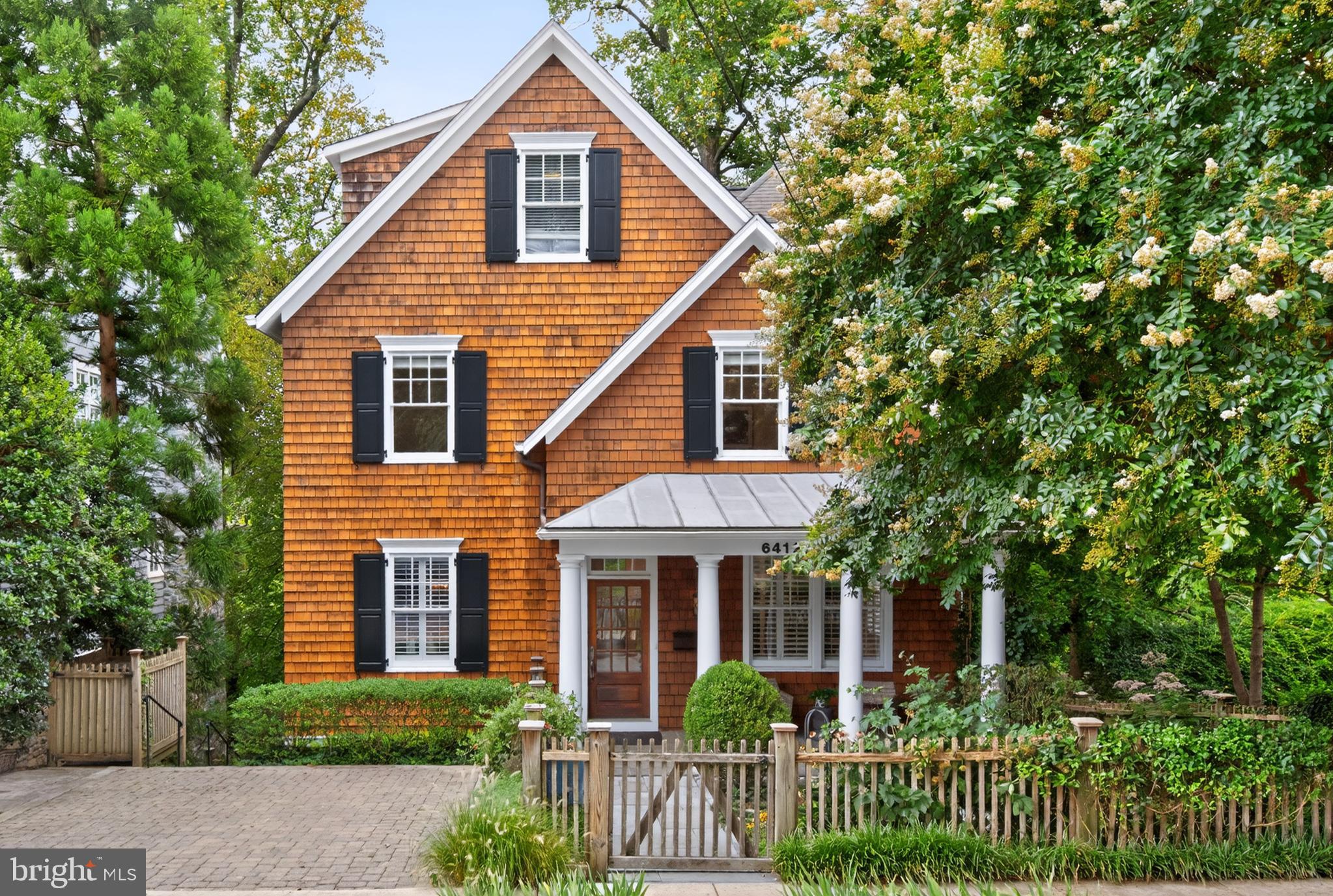 Rare opportunity in coveted Brookmont! Perched above the C&O Canal and Potomac River, 6412 Ridge Drive boasts 5,200 square feet of ideal living with gorgeous views, soaring ceilings, beautiful millwork, light filled rooms and more! The home charms guests with its picket fence, lush gardens and welcoming front porch. The main level features formal living and dining rooms, a spacious island kitchen with Sub-Zero refrigerator and Wolf gas range, butler’s pantry and desk area, powder room, and large family room with a gas fireplace and walls of windows and french doors leading to both a screened in porch and deck surrounded by the foliage of mature trees and the river beyond. The second level includes a large primary suite offering the perfect oasis in the treetops with gorgeous views, gas fireplace, dual walk-in closets and full bath complete with a soaking tub along with two additional bedrooms, full bath and large laundry room. Continuing up the wide, sun drenched staircase to the third floor is an open family area with balcony, full bath and fourth bedroom. Two additional bedrooms are found on the lower level along with a full kitchen, bath, laundry, separate entrance and spectacular living/recreation room with soaring ceilings offering more living space or the option of closing it off from the home to rent as a fully licensed ADU. Known for its remarkable location less than a mile from the DC line, Brookmont is loved for its weekly farmer’s market, community events, and green spaces including a playground, tennis court and playing field just one block away. This bucolic setting with access to hiking and biking trails and the Potomac River is also just blocks from the shops of Sumner Place, and the Palisades and Glen Echo beyond and residents enjoy quick commutes to work, schools, airports and beyond thanks to its proximity to commuter routes.