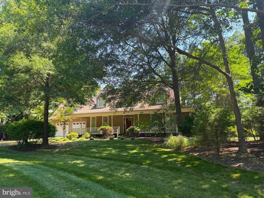 Private waterfront retreat on Mill Creek offering beautiful views, spacious living, and all the peace and quiet you have been looking for. This custom-built Cape-style home is nestled on a serene, protected stretch of water and offers the ideal blend of comfort and tranquility. With 4 bedrooms and 3 full baths, the home features a flexible floor plan designed for both everyday living and entertaining. A cozy wood-burning fireplace anchors the open-concept great room, while large windows frame tranquil water views and flood the home with natural light. Beautiful hardwood floors flow throughout the main living areas, while two main-level bedrooms offer convenience and flexibility, including the Primary Suite with direct deck access. Step outside to a wraparound composite deck and enjoy your morning coffee overlooking the water—or take in the peaceful views from the bright breakfast area.  Upstairs, you will find two additional bedrooms, and a spacious bonus room that could serve as a game room, media space, or guest bedroom. The full unfinished basement offers high ceilings and is ready for your vision—whether you're dreaming of a workshop, home gym, or additional living space. An oversized, climate-controlled two-car garage offers plenty of room for storage and projects. Outside, a private dock with 3 ft MLW includes an 8,000 lb boat lift, additional slip, a swim platform, and direct access to Mill Creek for boating, fishing, and crabbing. Spacious, private, and designed for comfort and connection—this is Eastern Shore waterfront living at its finest. Do not enter the property without an appointment.