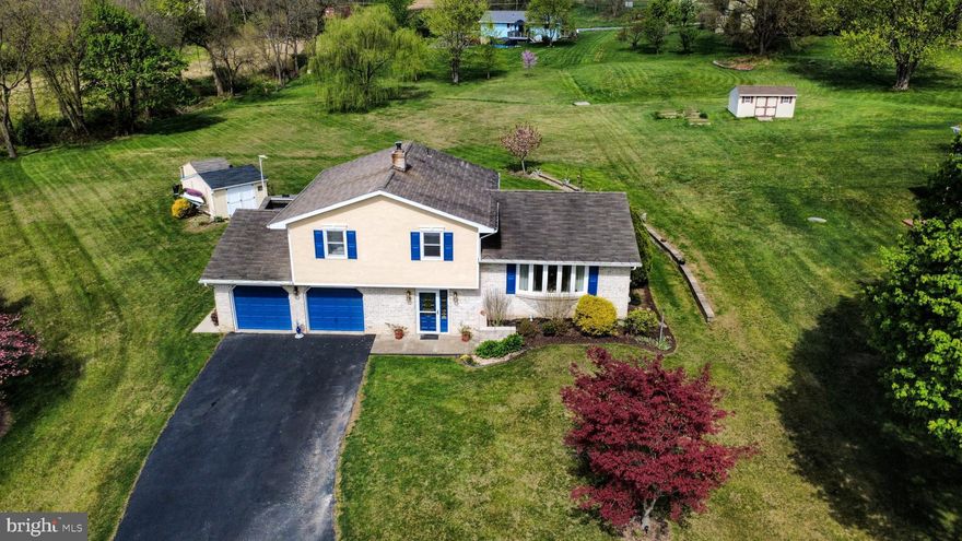 A great country setting waits for you. Nestled on a one acre lot at the end of a cul de sac, this 3 bedroom 1.5 bath split level is great for relaxing and entertaining inside and out. Hardwood floors on the 1st and 2nd floors. The living room is bright and warm with light from the bay window. The dining room and kitchen look out to the rear yard adjacent to farmland and local ballfields. The kitchen have epoxy coated granite counters, brick backsplash, glass top oven, microwave, dishwasher and LifeLock waterproof flooring. Bedrooms are carpeted and have hardwood underneath. The lower level family room has a wood/coal insert and additional hydronic heaters, carpet squares over tile floors. Then wander to the sunroom and to the covered patio for outdoor entertaining. There is also an outdoor firepit, fountain and planting beds. The yard is an expansive acre with 2 sheds one with electric. The basement contains the laundry and a den/office with gun safe. 200 amp service, radon fan installed. Heat Pump and central air conditioning plus a 20x25 2 car garage. Far enough to be quiet and peaceful yet close enough to major routes, entertainment and shopping.