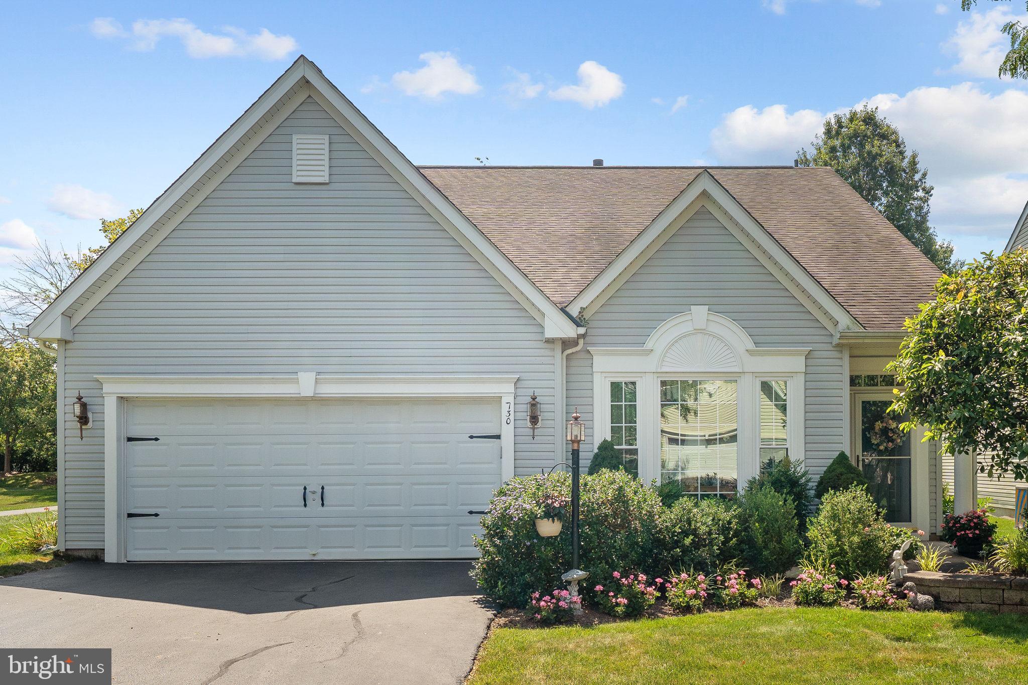 Welcome to this exceptional highly desirable Mayfield model located on the perimeter of the award winning Traditions at Skippack active adult community. As you enter the dramatic two story foyer you will experience a very tastefully decorated home with harmonious neutral shades throughout the home, expansive millwork with crown molding in the foyer, living room and dining room. Beautiful gunstock hardwood flooring welcomes you in the entrance foyer. The living and dining room have neutral carpeting that continues in the hallway to the spacious kitchen. The bright and cheerful newly remodeled kitchen with classic ceramic tile flooring includes beautiful white cabinetry, complimentary black granite surfaces on the counter and a large island for dining and culinary activities. A beautiful tile backsplash, plantation shutters, an expanded pantry, and newer stainless appliances, complete this wonderful kitchen. Large windows in the dining area enhance this bright and cheerful kitchen. Adjacent to the bright kitchen dining area is an expansive family room with vaulted ceilings, a ceiling fan, and a cozy marble highlighted gas fireplace to enjoy on the cold winter days. The family room has neutral plush carpeting for a cozy feeling. Adjacent to the family room is the convenient covered patio with a very scenic wooded view to relax and unwind during the warm weather. The expansive first floor primary bedroom, conveniently located off the family room, provides a sitting area, tray ceiling with ceiling fan. The many windows with new blinds in this large bedroom provide a bright and cheerful atmosphere. The luxurious neutrally decorated primary bath with ceramic tile, provides a wonderful soaking tub, an updated double vanity with neutral surface, designer fixtures and mirrors, and a large stall shower. The first floor also includes a very convenient butler's pantry, guest powder room, and laundry room with convenient storage cabinetry. The carpeted stairway leads to a large second floor that includes two full-sized bedrooms with convenient closets, a full neutral décor bath with shower tub. This carpeted loft area is also a great retreat for guests to relax and enjoy some privacy during visits. There is also a large storage area accessible from one of the bedrooms. This wonderful home has all new windows, a whole house humidifier, multi room speaker system, a smart thermostat, and a planting bed irrigation system. This exceptional community provides residents a beautifully decorated clubhouse with great room, library, exercise room and billiards room. A large heated community salt water pool is provided for residents and guests to enjoy in the warm weather. A multi use tennis and pickle ball court are also available. A convenient walking path winds through the community to exercise safely. There are many nearby shopping and dining areas in the charming Skippack Village, and the expansive Provincetown shopping, dining, and entertainment complex in Collegeville. This exceptional home has been meticulously maintained and is truly in “move in” condition. If you’re looking for home in this great active adult community, act quickly!