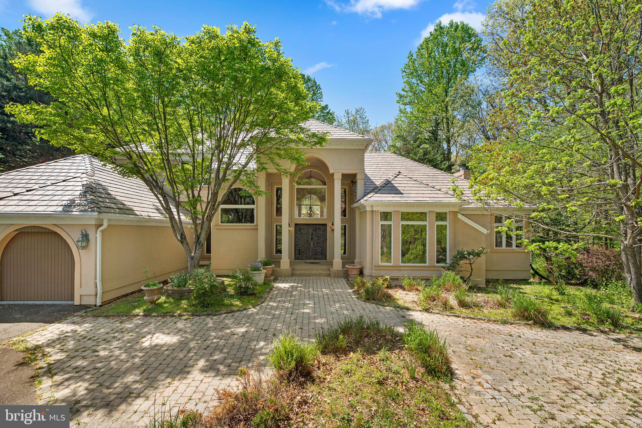 A beautiful Spanish contemporary style home with Santa Fe influence surrounded by Rock Creek Park at the end of private cul-de-sac. Your own private oasis where you can have serenity.
This enormous light-filled custom-built home has black walnut hardwood floors all through out the main level and the second level, hand carved 20 piece door set from New Mexico with Bouvet handles - made in France, Custom forged iron stearway rails. Cathedral Great room - has 20 foot ceilings. New synthetic slate roof and fresh paint. A total of 68 windows. High ceilings throughout the house. Two fireplaces, one of which in the primary bedroom. Internal balcony over the great room. Geothermal VAC system with a heatpump - backup furnace as well.
The main level features the primary bedroom with two walk in closets and a full primary bathroom all in grey marble, imported - hand painted sinks, bidet and jacuzzi. Full granite countertops in the kitchen with a full stainless steel set of appliances.
The upper level has two separate bedrooms with two separate full bathrooms. As well as the library with a private study.
The lower level is fully finished which features a bedroom with a full bathroom, sauna steam room with a separate dedicated bathroom, Double sitting room near the steam room, Home theater which is also an activity area, with a separate dedicated office with a full bathroom. Wine cellar parallel to the home theater.
The garage has space for two cars but there is additional parking that leads to a separate entrance to a private office.
The lot is 3 acres plus and immersed in the park.
You will be captivated when touring this home - breathtaking custom style that is like no other. Different from any other house, elegant, and stylish.