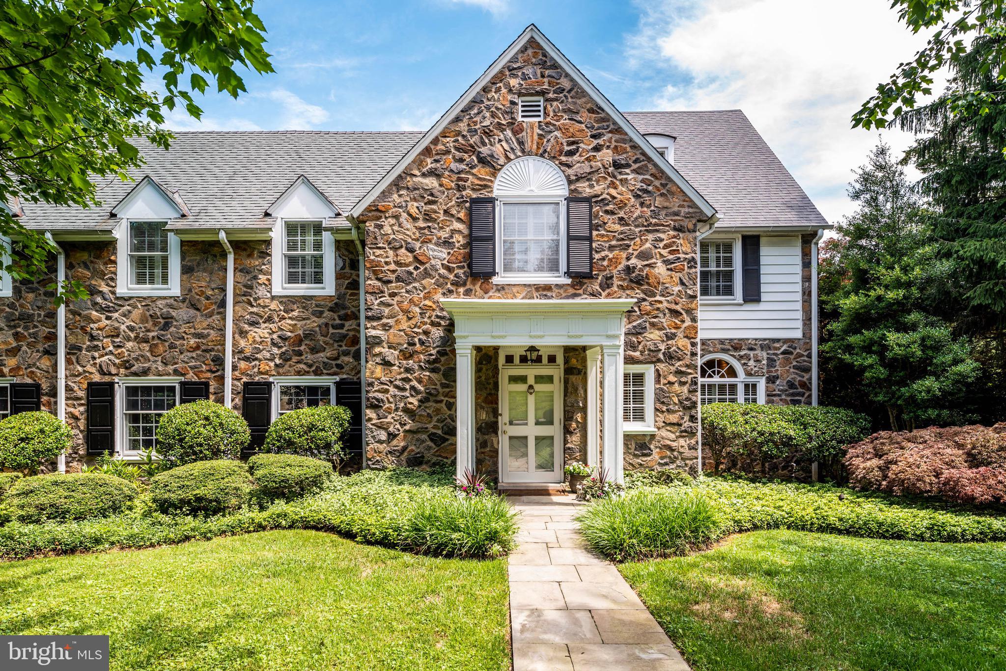 This exquisite Wallace & Warner stone Colonial home has been meticulously renovated and combines old world charm with full modern conveniences. The first floor offers an elegant Reception Hall, grandly proportioned step -down LivingRoom, Sun-filled Dining Room, a Den, a large Family Room, and a completely renovated Gourmet Kitchen & Breakfast Room featuring Mouser Custom Cabinetry, granite countertops and top-of-the-line appliances and backstairs to the second floor. The first floor offers 9Ft plus ceilings, hard wood floors throughout and a powder room. The second floor is accessed by a turned staircase and boasts a Main Bedroom Suite with renovated Bath & secondary Laundry, another ensuite Bedroom with new bathroom and two additional Bedrooms, with adjoining bath, and a spacious second floor Family Room. The third floor offers 2 Bedrooms and hall Bath. Enjoy recreation and movies, an Exercise Room and more in the fully renovated Lower Level which also has a Powder Room, an expansive Mudroom area and a walkout entrance to the garage and driveway. This gracious home is ideal for grand entertaining, comfortable family living and is located in a beautiful Northside Bryn Mawr neighborhood! https://player.vimeo.com/video/438998966
