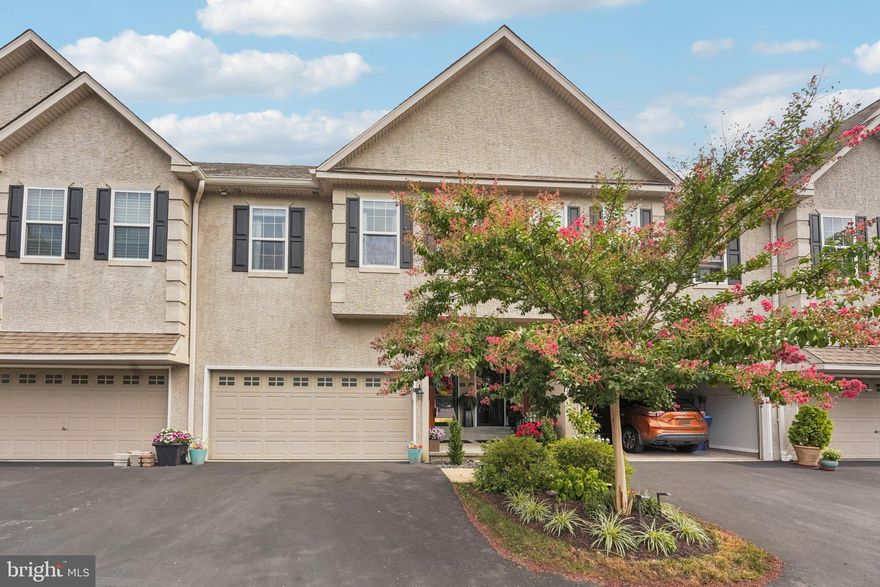 Nestled on a private dead-end street in the desirable Spring House Lane community, this impeccably upgraded luxury townhome offers direct access to the scenic walking trails of Coopersmith Park. A charming covered arched front porch welcomes you into a beautifully appointed foyer with classic board and batten detailing. The open-concept main level features luxury vinyl flooring throughout, connecting a formal dining room with a new chandelier to a spacious living room complete with a cozy fireplace and remote-controlled shades. The remodeled eat-in kitchen is a showstopper, boasting an oversized island with seating, custom cabinetry with under-cabinet lighting, Quartz countertops, a farmhouse sink, high-end Viking appliances, and a pantry. Sliding doors from the breakfast nook lead to a newly extended Trex deck overlooking tranquil wooded views. A stylishly updated half bath with a new farmhouse-style vanity and efficient toilet, along with interior access to the two-car garage featuring epoxy floors with a lifetime warranty, complete the main level. Upstairs, you’ll find three generously sized bedrooms with luxury vinyl plank flooring continued throughout. The serene primary suite offers his-and-hers custom walk-in California Closets and a spa-inspired ensuite bath with a glass-enclosed walk-in shower, soaking tub, dual vanity, and private water closet. The two additional bedrooms also feature custom California Closet systems and share a well-appointed hall bath. A conveniently located upstairs laundry room includes an LG washer and dryer and additional built-in shelving by California Closets. The fully finished walk-out basement offers versatile living space with a stone-faced fireplace, perfect for a media room, gym, or office, and opens to a beautifully stained concrete patio for seamless indoor-outdoor living. Additional upgrades include fresh paint throughout and new light fixtures over the kitchen island and breakfast table. Ideally located just minutes from shopping, dining, medical centers—including a hospital and pharmacy—and with easy access to major highways, this exceptional townhome blends luxury, comfort, and convenience in one perfect package. Mortgage savings may be available for buyers of this listing.