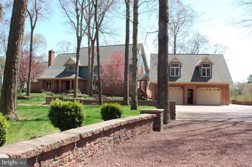 This private waterfront estate offers fantastic views from every room. Surrounded on 3 sides by Perkins Creek, take your boat off the lift and spend the day cruising the St. Martin River followed by dinner at one of the many dockside restaurants in Ocean City. Open floor plan with huge master suite, stacked stone fireplaces in great room and family room. Huge gourmet kitchen makes entertaining large groups easy! Finish the evening with a glass of wine in the hot tub. Large in-law suite is bedroom #5 or use a game or theater room. Additional 2000 sq. ft. outbuilding for your shop and toys! A must see. Call Mike for your private tour!