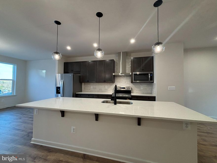 *NEW CONSTRUCTION* Special All-In Price, for April Move-In! Step into the Potomac, a superior 3-level townhome with a 2-car garage in the sought-after Cascade Landing community in Dumfries, VA. This thoughtfully designed home offers 4 bedrooms and 3.5 baths, all with 9 ft. ceilings for an open, airy feel. The gourmet kitchen is a showpiece, featuring upgraded maple slate cabinets with brushed nickel hardware, quartz countertops, ceramic tile backsplash, range hood, and stainless-steel Whirlpool appliances. Designer laminate flooring flows throughout the main level, including the kitchen, walk-in pantry, dining room and great room. The luxurious primary suite includes a generous walk-in closet and a spa-inspired bathroom with raised double vanities, quartz countertops, and a shower with designer ceramic tile. Plus, the garage includes an EV charger-compatible outlet, making this home future-ready. Receive up to $20K in YOUR CHOICE of savings until 3/31 (restrictions apply; see New Home Counselor for details). Hometown heroes get $5,000 until 3/31 (restrictions apply; see New Home Counselor for details). Enjoy low-maintenance living with affordable HOA dues (no hidden developer fees) so you can put your savings toward what matters most. Cascade Landing offers a welcoming neighborhood with a playground, easy walkability, and quick access to premier parks and trails. These advanced performance homes save you money on utilities while reducing your carbon footprint. Located just 2 miles from Marine Corps Base Quantico (North Gate) and 2.5 miles from I-95, commuting is effortless. Plus, you’re close to Fortuna Center Plaza, Locust Shade Park, and dining favorites and entertainment. Photos of similar home. Model Home Hours: Mon–Sun, 11 AM–6 PM. Use 17910 Alicia Avenue, Dumfries, VA 22026 for GPS directions. Please go to the model home listed here first.