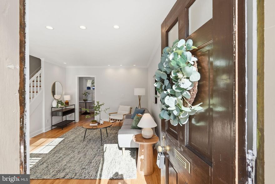 Tucked into the peaceful, wooded setting of Arlington Village, this charming townhome-style condo offers the perfect blend of historic character, thoughtful updates, and serene surroundings. Located in a quiet lower ravine overlooking lush greenery, the home welcomes you with a sunny front garden and private outdoor spaces, including a brand-new rear deck (2024) and a newly landscaped native plant garden. Inside, you’ll find hardwood floors throughout, plantation shutters, crown molding, and oversized baseboards that add warmth and style. The light-filled living room features recessed lighting and a convenient coat closet, while the beautifully updated kitchen offers white shaker cabinetry, stone countertops, tile backsplash, upscale appliances, a Hydroviv water filtration system, and a stacked GE washer and dryer discreetly tucked into a closet. Upstairs, the spacious bedroom includes two closets—one with built-in shelving—and a large built-in desk with excellent storage. The full bath features granite tile flooring, fully tiled walls, and classic finishes. Replacement double-pane windows provide energy efficiency and easy tilt-in cleaning. The condo fee includes all of those amenities, water, trash, sewer, parking, exterior maintenance and on-sight management. The location is exceptionally convenient: walkable to Columbia Pike with grocery stores, coffee shops, and a wide variety of restaurants, plus easy access to multiple transit options for quick trips into Arlington and DC. Quiet, historic, and well-situated, this home offers a simple, efficient layout and strong everyday livability.