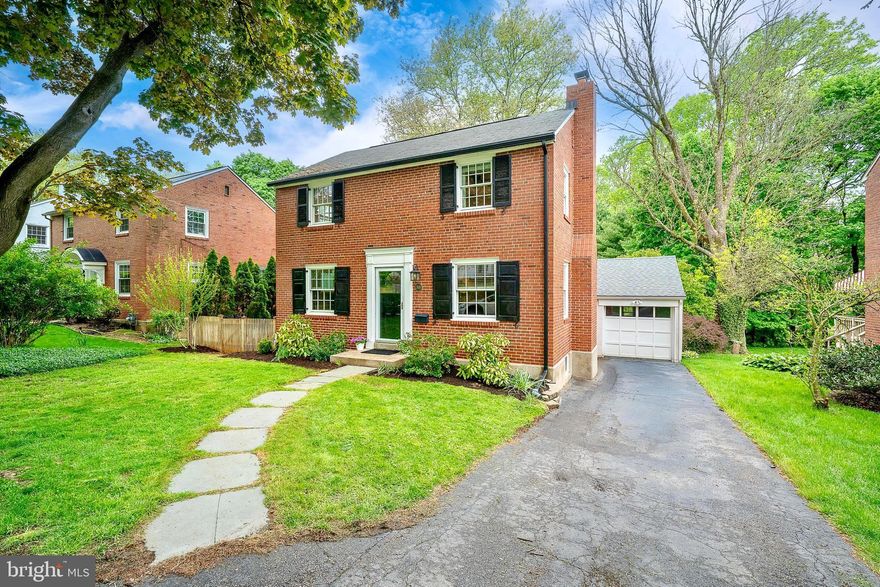 Welcome to 305 Eagle Road, a storybook brick Colonial perfectly located just blocks from the heart of downtown Wayne. From the moment you arrive, this lovingly maintained home feels warm, inviting, and full of charm, offering the ideal blend of classic Main Line character, thoughtful updates, and a walkable Wayne lifestyle. Inside, beautiful hardwood floors run throughout the home, connecting bright and comfortable living spaces designed for everyday living and easy entertaining. The spacious family room is centered by a gas fireplace and flows seamlessly into the dining room, where a charming built-in corner cabinet adds timeless detail. The updated kitchen features granite countertops, stylish cabinetry, hardwood floors, and new stainless steel appliances, including a counter-depth refrigerator. Upstairs, you’ll find three bedrooms and a beautifully appointed full bathroom with an updated vanity, tile, and a glass sliding shower door. Each bedroom offers beautiful hardwood floors, wonderful natural light, and custom built-in closet organizers, while the primary bedroom provides the added benefit of two separate closets and ample space.
The outdoor living space is one of the true highlights of the property. The fully fenced backyard is beautifully landscaped with perennial gardens and offers multiple places to gather, relax, or entertain, including a recently painted rear deck with new railings, a side patio, and a tiered yard with room for play, gardening, and outdoor enjoyment. A detached garage opens conveniently into the backyard, while the charming garden shed with flower boxes serves as a picturesque centerpiece. Additional features include a new HVAC system in 2023, Pella windows, updated exterior motion lighting above the garage, and beautifully maintained gardens surrounding the property. Located in the award-winning Radnor Township School District and just minutes from the Wayne and Strafford train stations, local restaurants, shops, and the beloved Wayne Farmers Market, this home offers both convenience and character in one of the area’s most desirable settings. 305 Eagle Road is a wonderful opportunity to enjoy charm, updates, outdoor space, and walkability in a truly special Wayne location.