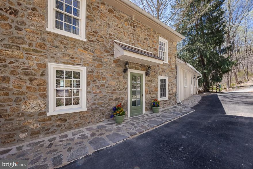 An extraordinarily tranquil and private setting provides the backdrop for this stunning home and property near the charming Village of Birchrunville. The beautifully landscaped property provides abundant open space with outstanding views of the backyard, surrounding woodlands and the pond. The home’s welcoming foyer leads to the newly renovated gourmet kitchen with random-width heart pine flooring, exposed fieldstone wall, built-in cherry dining table and a cozy sitting area with natural stone tile. Additional features include new quartz countertops, cherry cabinetry, two islands and top of the line appliances including: a custom paneled Sub-Zero fridge, new 5-burner induction cooktop, S/S convection oven, microwave and new dishwasher. The kitchen leads to the dining room with hardwood flooring, exposed stone and sliding doors leading to the deck, an ideal spot for entertaining friends and family or to simply relax and enjoy the sights, sounds and all that Mother Nature brings your way. The main level also includes a living room with a built-in bookcase, a bedroom (currently a home office) and a powder room. Retreat upstairs to the gracious master bedroom and en-suite bath. The master bedroom has hardwood flooring, exposed stone and deep windowsills. The beautifully remodeled en-suite bath features a glass enclosed shower, granite-topped double vanity sinks and a soaking tub. The spacious lower level features a family room with brick flooring and brick hearth with a Harman pellet stove, exposed beamed ceiling and sliding doors leading to a patio overlooking the backyard; a study/office (currently a music room), a full bath, laundry room and access to a second stone patio overlooking the private yard. There are two additional bedrooms on the lower level, one with a wood-beamed loft and the other with exposed beams and a Harman pellet stove. The beautiful stone bank barn is ideal for recreation and entertainment and features exposed stone walls and wood flooring. The lower barn can accommodate horses and has abundant storage space for tools and equipment. Take a stroll to the pond to enjoy fishing, swimming, or simply relax in the tranquil haven. Please make an appointment to visit this extraordinary home and property. For the outdoor enthusiast, West Vincent Township offers endless opportunities for cycling, nature walks, horseback riding, fishing and birdwatching. A very peaceful setting, yet convenient to premium shopping and major commuting routes (76, 202, 422, 100).