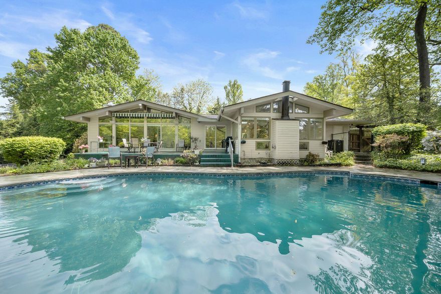 Set on nearly an acre in a quiet cul-de-sac in Bethesda’s highly sought-after Oak Forest neighborhood, this light-filled, California-style contemporary home offers 3 bedrooms and 3.5 bathrooms. The open-concept layout features a modern kitchen, three gas fireplaces, hardwood floors, and abundant skylights that fill the home with natural light. The expansive, private lot is truly exceptional, complete with a circular driveway, pool, tennis court, gazebo, and storage shed—ideal for outdoor entertaining, relaxation, and everyday enjoyment. The spacious primary suite includes a walk-in closet and a serene private outdoor retreat. The walkout finished basement adds valuable living space with a large recreation room, wet bar, laundry area, and generous storage. A two-car garage includes additional storage and is equipped with an electric vehicle charging station. Ideally located inside the Beltway in the Walt Whitman school district, this home offers convenient access to downtown Bethesda, shopping, dining, and Metro, with easy commuting to Washington, DC, Virginia, and major thoroughfares.