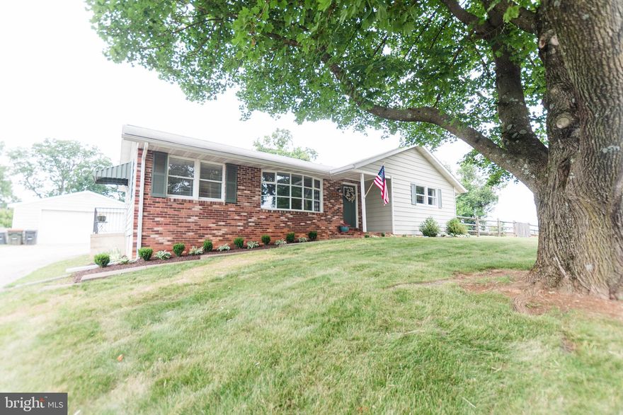 This gem of a home is completely move in ready! Large kitchen with granite countertops, stainless steel appliances, wood burning fireplace and sliding doors leading to the new stamped concrete patio and fully fenced large yard.  3 large bedrooms and two full baths add to the main level. The huge basement is ready to be finished to your liking  for double the living space! The oversized detached garage provides additional parking as well as space for a workshop. Conveniently located within close proximity to shopping, restaurants, schools, and commuter routes while providing beautiful Carroll County views.