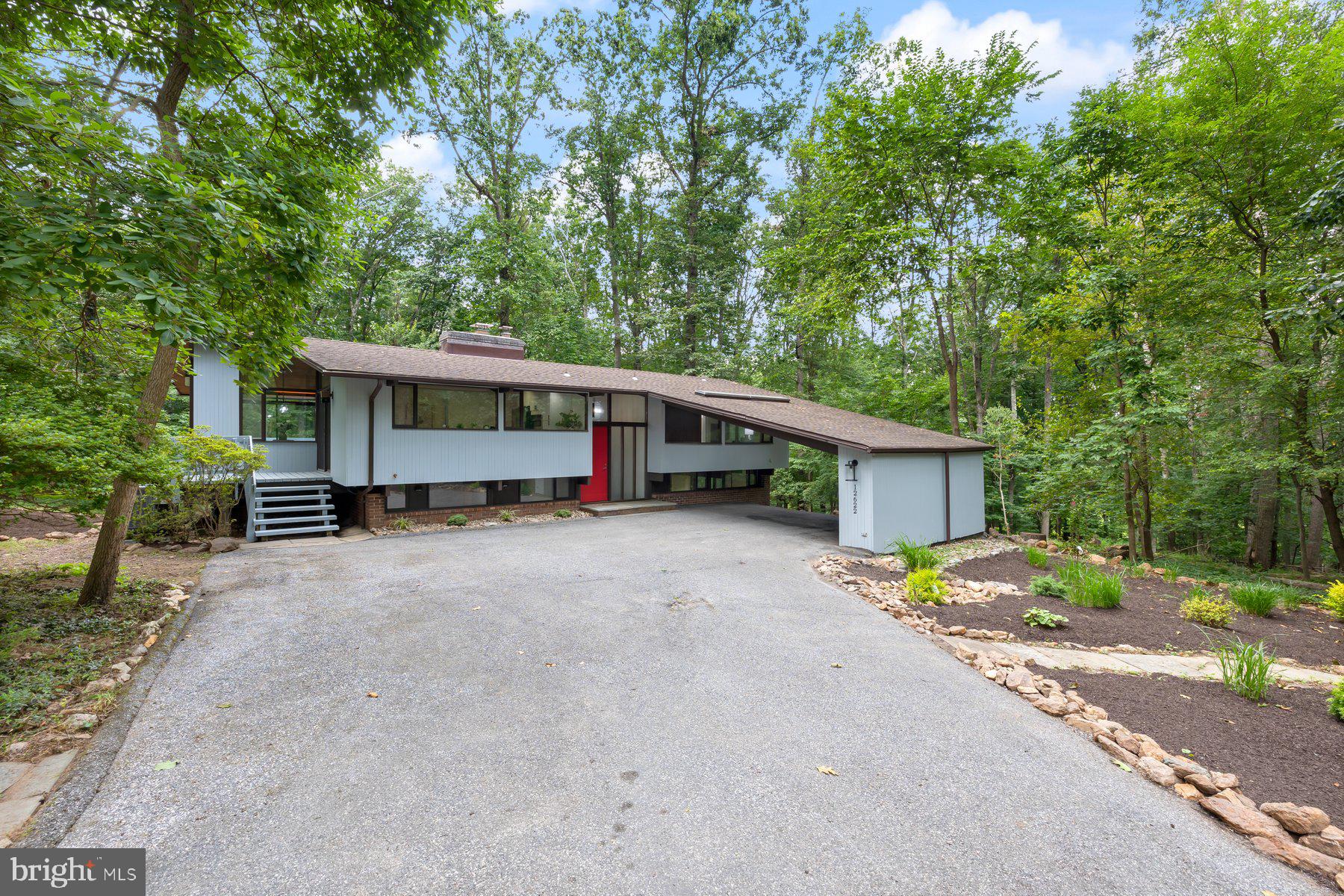 Come make your mid-century modern dreams come true with this custom contemporary home featuring walls of glass and soaring wood ceilings!
Nestled in Sagamore Forest, enjoy the serene landscape situated on a 1.67 acre lot. Surrounded by trees with views of nature in every room and a deck extending the full length of the home.
Crafted by Acorn Deck House Company in 1979, known for award winning designs and recently renovated in 2025 for today’s lifestyle.
Exposed beams create an open large living and dining area with beautiful mahogany hardwood floors and wood burning fireplace.
The newly remodeled kitchen has generous cabinet space, quartz countertops, stainless steel appliances and island with casual seating.
The primary suite is conveniently located on the main level with a remodeled bath, slider to deck, and an adjoining bedroom- perfect for a dressing room, home office, or can easily be converted back into a separate bedroom.
The lower level has new luxury vinyl tile floors throughout and a wall of sliding glass doors each opening to the walkout patio. Enjoy your spacious rec room with cozy wood burning stove, two additional beds, full bath and laundry. Pull into your carport in style and make this yours today!