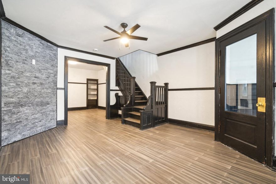 Ebony and Ivory. This spacious 3 bedroom Art Deco styled townhome is situated on a hill in the vibrant Overbrook community. Step inside and find the harmonious character and charm West Philadelphia homes are  beloved for.  Notice the contrast of the obsidian trim, and doors  complimenting the wide planked ash flooring consistent through out the living spaces of the home.  Chair rail and crown molding accents the rooms lending a quality feel to the space.  Updated throughout, this residence is move in ready with updated energy efficient windows. The kitchen lovely kitchen is outfitted with stainless steel appliances, natural stone countertops, with coordinating backsplashes. The exterior spaces are fantastic with a large front porch to sit and watch the world go by, as well as a fantastic back yard area where barbeques and gardening can be imagined. Upstairs find three generous bedrooms each equipped with ceiling fans, and nice closet space.  The bath is well appointed with large format stone tile, completely updated. The neighborhood of Overbrook offers great access to public transportation, as well as lots of restaurants and shops on nearby  Lansdowne and Lancaster Avenues. Schedule a tour today!