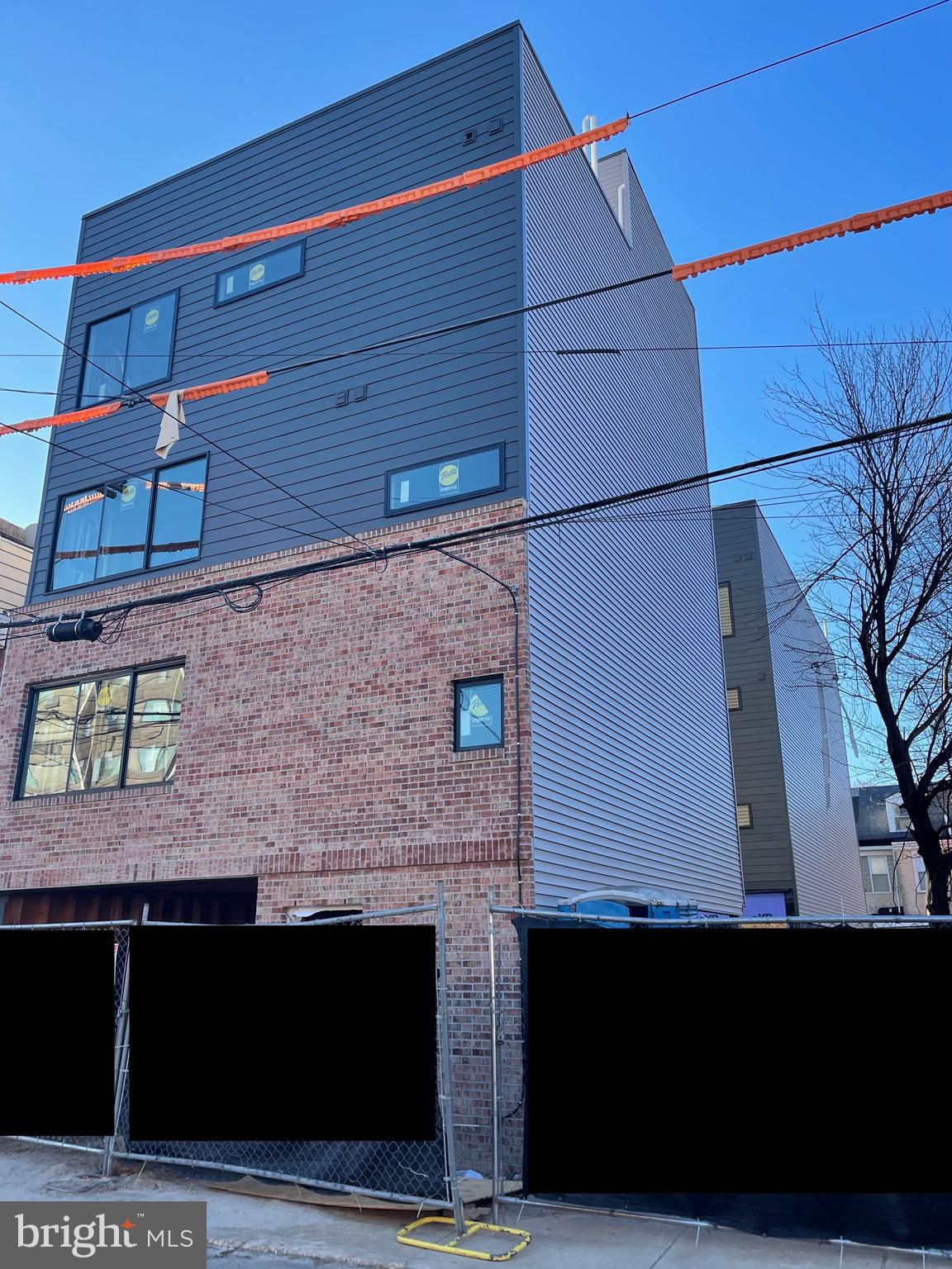 Welcome to 1306 N. Orianna Street - 4 thoughtfully designed condos with gated, covered parking on a quiet side street next to a community garden and a (soon to be renovated) park and playground (Hart Park) in the heart of South Kensington. Unit A offers a bi-level layout with 2 bedrooms, 2 full bathrooms and access to a rear shared outdoor space. The first floor has an open kitchen/living room area with huge sliding windows to let in all of the natural light you can imagine. The efficiently designed matte black kitchen with quartz countertops and upgraded stainless steel appliances was created to maximize living room space while still being super functional and fun to cook in. Additionally there is a large bedroom, full bathroom and a convenient coat closet. Continue up a flight of stairs to your primary living quarters with another great sized bedroom, full bathroom, closet and stacked washer and dryer. The unit is outfitted with efficient and easy to care for ductless split AC units and comes with the original FULL 10 year tax abatement (NOT the new tax abatement). Low condo fees make this condo an affordable option. Coveted covered, gated PARKING included in the listing price! You’ll never need to use your car though, because the location is so incredible, you are located directly between Fishtown and Northern Liberties giving you the best that all 3 neighborhoods have to offer! Winter Delivery. In-person tours available by appointment only. Photos included are from work completed by the same reputable developer/builder, is located down the street and is available to be toured as well as the subject property to get an idea of level of finishes/fixtures. Inquire for details about additional, larger remaining units available for purchase. Square Footage listed is estimated.