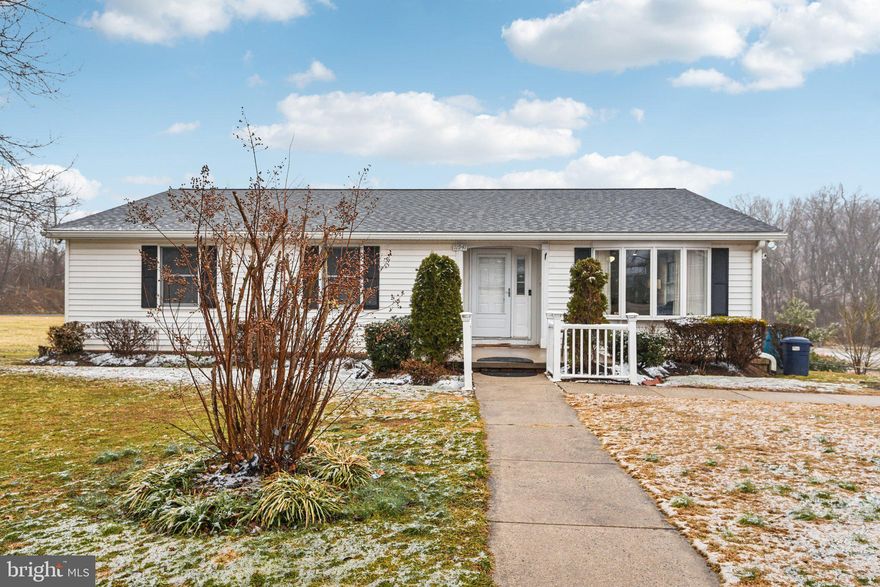 Welcome to this move-in-ready ranch-style home, where effortless single-level living meets thoughtful modern updates. The exterior features a classic white siding with black shutters, complemented by a tidy front yard. Inside, the home opens to a bright and spacious living room characterized by warm wood-toned flooring, recessed lighting, and a modern ceiling fan. The heart of the home is the expansive kitchen, which showcases rich oak cabinetry, durable granite countertops, and a functional peninsula with a built-in cooktop. Unique architectural details, including exposed ceiling beams and an interior decorative window, add a touch of character to the main living areas. The layout flows seamlessly into a dedicated dining room accented with classic chair rail molding. From here, sliding glass doors lead to a large rear deck, providing the perfect venue for outdoor entertaining overlooking the backyard. The home's comfortable accommodations include bedrooms with generous closet space and a versatile primary bedroom with en suite. The walk-out basement offers additional living space that's perfect for entertaining or a potential in-law suite with a functional bedroom, full bathroom, and bonus room that could be used as an office/hobby room. The backyard provides views for miles as the lot is adjacent to open fields with mature trees. With its neutral palette and sun-drenched rooms, this residence offers a clean canvas and a peaceful lifestyle in a convenient location in the heart of Libertytown.
