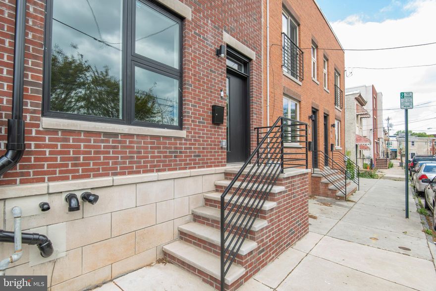 Virtual tours and contactless tours available upon request. Welcome to 424 N Sloan. This unbelievable home is situated on an amazing block, directly across from a cute park with picnic table in the heart of west powelton village, with gorgeous views from both roofdecks (thats right, there are two of them). You will not believe how big this home is. Step up to the beautiful classic brick facade, and enter the home through the 8 foot steel door (guests can use the Ring doorbell system!). The sprawling first floor will make your jaw drop. Eleven foot ceilings make the HUGE open-concept space feel even greater. Glowing hardwood flooring from all the natural light, recessed lighting, a built-in electric fireplace and the first of two nest thermostats are just some of the standouts that make up the first section of the 1st floor. Up a couple steps, seperated with cast iron horizontal railings, is the massive kitchen and dining area. Perched slightly above the rest of the 1st floor, the space and the chefs kitchen are a dream. Quartz countertops, custom cabinetry, high-end stainless steel appliances, push button disposal, pot filler, range hood, built in microwave, 8 ft island with waterfall features, wine rack with wine fridge, multiple pantries, etc.  Through massive triple 8 ft glass sliders, step out to your elevated deck/rear yard, the first of 4 outdoor spaces.Upstairs, the high ceilings and hardwood floors continue. There are 2 HUGE bedrooms, each with, recessed lighting, ample storage, and easy access to their own separate bathrooms.  The rear bedroom has glass sliders leading to a private deck, and the front has large anderson windows overlooking the park. The first bathroom on this level has a full shower, tiled all the way to the ceiling.  The second bathroom on this level has a tub/shower combo. Full size laundry and the second nest thermostat complete the second floor. The 3rd floor is a private oasis. Enter to the huge master suite, complete with his and hers massive walk-in closets with motion sensor light, a complete wet-bar with quartz countertop and under cabinet lighting, an over-the-top master bathroom, and a private roof deck overlooking the park with great views above it.  This bedroom is even bigger than the others, and with great natural light and modern ceiling fan, this space is something you need to see to believe. The master bath has heated lights, an enormous walk-in shower with bench, niche, and multiple shower heads. Not to mention the 6 ft double sink, a stand alone soaking tub with sleek tub filler, and marble and ceramic tiling. The roof deck has panoramic views, with built-in lighting all around. The full basement is unlike any you've seen.  With the step up from the kitchen, the basement ceilings are over 10'. With a larger than double closet and full bath, this space could easily be a 4th bedroom and 2nd living room, or more.   Less than a 2 minute walk to hospital and police station, less than a 10 minute walk to drexel, and yet quiet and unassuming.  This home is special. Apply today