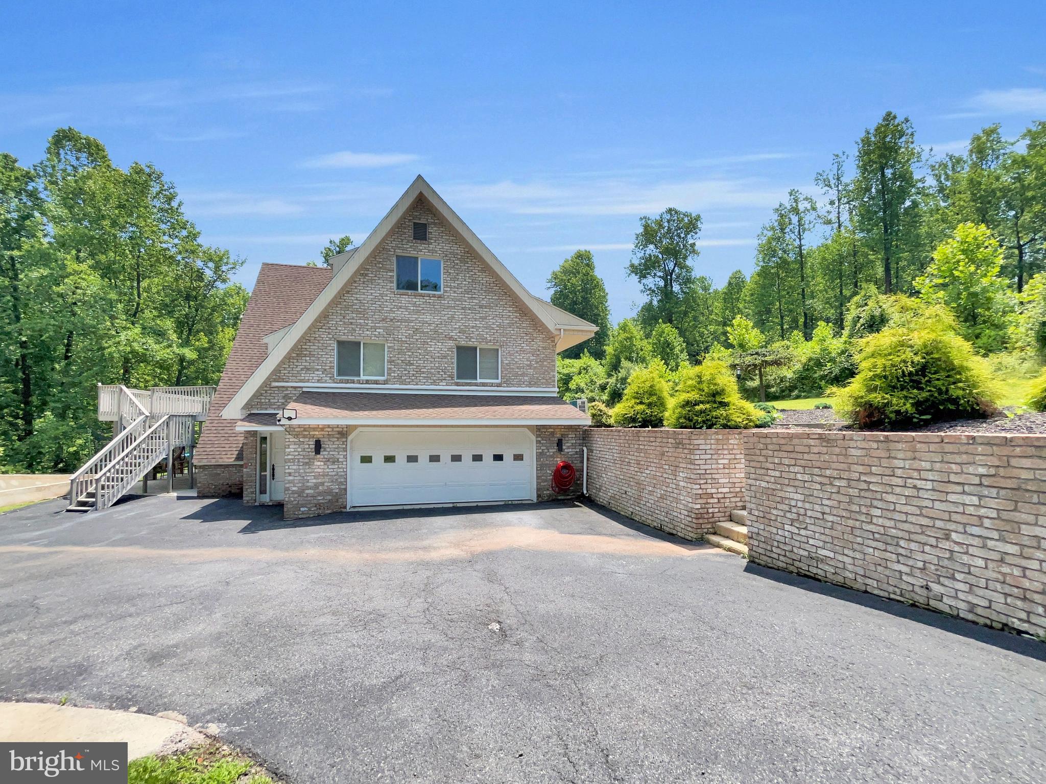 Gorgeous Custom 5 Bedroom and 4.5 Bathroom Contemporary Home set at the end of a long driveway on over 21 private and peaceful acres in Cumru Township. Fully renovated from top to bottom in recent years, this exceptional home offers a rare blend of luxury, versatility and privacy. Featuring not only complete In-Law Quarters on the Lower Level but also 2 Bedroom Suites on the Main Level. The tone for this elegant home is set upon arrival as you emerge from the wooded drive into a sunlit clearing and are greeted by the large home's impressive presence. Once inside the Main Level features an open concept Kitchen and Living Room Area. The Chef's Kitchen features quartz counter-tops and stainless steel appliances and the adjoining Living Room centers around a Fireplace and opens directly to a deck overlooking the serene surroundings. The 2 Bedroom Suites on this level each include a private Bathroom and an ample closet space. Downstairs, is a full In-Law Quarters offers ideal multigenerational living with its own Kitchen, Living Area, Bedroom and Bathroom. Upstairs, there are 2 Bedrooms and an additional Bathroom as well as a vaulted ceiling Family Room. Additional highlights include 2 Laundry Rooms, attached oversized 2 Car Garage, Storage Shed and subdivision potential. Schedule tour private showing today and come and experience all that this stunning property has to offer first hand!