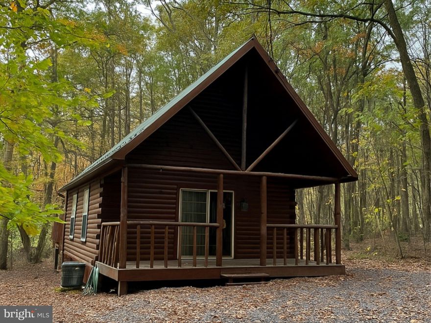 Welcome to your peaceful sanctuary nestled among the trees! Step inside to a warm and inviting open-concept living area with vaulted ceilings, exposed log beams, and a  fireplace perfect for cozy nights.This rustic yet 2 bedroom 1.5 bathroom log cabin offers the perfect blend of seclusion and comfort. Tucked away on 1.34 acres  surrounded by nature