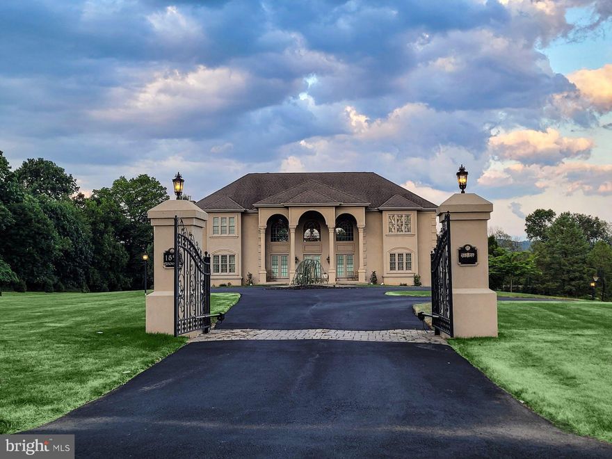 Open and infused with sunlight, this remarkable Saucon Valley home is a custom design defined by its sensitivity to the marvelous vistas, with each room enhanced by walls of glass to take advantage of the serene environment. Exceptional living spaces open to patios and balconies balanced above an outdoor area and a recently renovated pool and lush lawns, on over five acres. At every turn, in each carefully conceived room, attention was given to architectural detail, and to the placement of elegant windows, arches and doorways.

Springwood offers more than 7,876 square feet of living space on three full levels. Befitting the demands of today’s family without sacrificing luxury, there are rooms for every need or hobby, designed for large or small family gatherings. The gourmet kitchen flows seamlessly into the great room, combining dramatic inside spaces with the views of natural surroundings.

Additionally, Springwood offers a commanding front entrance with dual staircases and dramatic ceiling heights. Six plush bedrooms and four full baths easily accommodate a full house. A first floor primary suite is an intimate retreat, with a sumptuous primary bath. An elevator runs from the first floor to the finished lower level with game and recreation rooms. A four-car garage and  2023 roof make for ease of living.