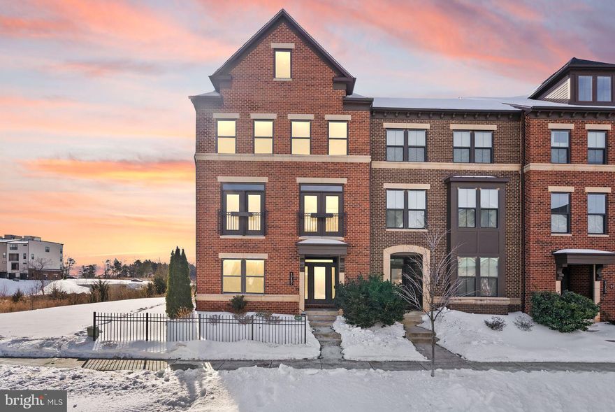 FOR SALE!  Immaculate, sundrenched END UNIT townhome with thoughtful design across all four levels about half mile from the Ashburn Metro - spacious with 5 bedrooms, 4.5 baths, 2 car garage, over 3700 square feet, with balcony and rooftop terrace with spectacular views.  This home is perfectly positioned on a premium lot backing & siding to a conservation area!

The entry level features durable engineered hardwood flooring throughout, a private bedroom with walk-in closet, and a full bath with granite countertops and upgraded floor and shower tile.  A convenient arrival center provides the perfect spot for coats, shoes, and everyday essentials.  The 2 car garage conveys affixed metal racks/shelves for extra storage.  

Oak stairs with sleek metal balusters set the tone to the main level, an entertainer’s dream, showcasing an chef’s kitchen with an expansive and impressive quartz island, 5-burner cooktop, vented hood, classic white cabinetry, upgraded faucet fixtures, and a stunning glass backsplash. The space is enhanced by Juliet balconies, an electric fireplace, a customized pantry, and a balcony (complete with a convenient gas line for your grilling needs) - perfect for outdoor entertaining. 

Upstairs, the third level also offers engineered hardwood in the hallway and bedrooms all equipped with ceiling fans.  The primary suite impresses with 3 closets, as well as a luxurious spa-like bathroom with dual granite vanities, a frameless shower with dual rain showerheads, custom shower tile, and upgraded flooring.  The hall bath features dual vanities with granite counters and upgraded floor and shower tile. The laundry room includes upgraded front-load washer and dryer.

The fourth floor opens to a versatile loft space that can be used for a second living space, media room, or office, as well as a bedroom, and a full bath with granite counters and upgraded tile. Step outside to the large rooftop terrace (also with a gas line) to enjoy the beautiful sunrise and sunsets.

Brick front and side, whole house humidifier, oak stairs throughout, designer finishes, and exceptional attention to detail make this home truly stand out.

Westmoore is a premiere neighborhood with excellent amenities - 2 large parks with open spaces, 2 playgrounds, amphitheatre, dog park, pavilion, clubhouse, community pool, and fitness center.  The location is perfect - close to Broadlands Marketplace and Loudoun Station and everyday conveniences, and quick easy access to Dulles Greenway, One Loudoun and the Dulles Airport!