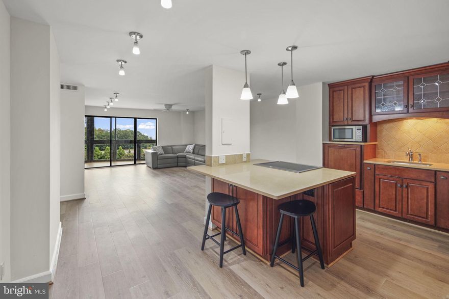 Absolutely stunning, one-of-a-kind unit with High-End custom upgrades and BRAND NEW Flooring! In addition to all upgrades, this condo has an enclosed balcony with extra 101 Sq. Ft. of living space! <p>


Step inside to discover a home transformed by thoughtful and tasteful renovations. The walls were removed to open the floor plan, flooding the space with natural light and giving this one-of-a-kind Model “B” unit sweeping views from almost every space.

The kitchen was completely redesigned with custom cabinetry, an island, and stainless steel appliances—making both cooking and entertaining effortless. Here, every detail has been carefully considered:<p>

    • Ceiling-height Kitchen Cabinets for additional storage<p>
    • Raised dishwasher for easier loading and unloading<p>
    • Corner appliance garage with built-in outlets to keep counters clear<p>
    • Built-in exhaust fan to keep air circulating while you cook<p>
    • Large Pantry with pull out shelving<p>
    • An Island with storage & sitting for three
    • and more...<p>

Custom built-ins in the living room can house your TV, books, décor, and media equipment—keeping the space organized and stylish. The bedroom boasts not one, but three closets—all with custom shelving to maximize storage.<p>

The updated bathroom offers a rare setup: two vanities, two showers, and a bathtub. From the living room, step to the enclosed balcony—your year-round retreat.  This home is truly designed for comfort, convenience, and style.<p>


<b>COMMUNITY </b>: Set on 34 acres, The Rotonda's Gated Community offers resort-style amenities and green spaces rarely found in urban living. Yet just outside the gates, it's surrounded by Tysons’ best shopping, dining, and entertainment, including: The Boro Center, Whole Foods Market, Tysons Galleria, Capital One Hall and two Metro Stations. Recently renovated Community Center (Domes in the center of the community) offers Library, Fitness Center, Yoga Room, Indoor & Outdoor Pools, Sauna, Game Room, Business Center, and more! Outdoor you’ll find Basketball, Tennis/Pickleball & Volleyball Courts, Walking Trails, EV Charging Stations, Putting Green, and Fenced-in Dog Play area. Please find outdoor amenities behind buildings #8340 & #8380. The community's recent renovations include: new carpets in every building on every floor; new tile flooring; new security system; new windows and balcony doors; new Front Door awnings on every building; and new Gate Houses.<p>

<b>LOCATION </b>: The Rotonda is surrounded by the best of Norther Virginia’s shopping, dining and entertainment, putting you at the center of it all. Just outside the gates, you will find The Boro Center with Whole Foods Market, Movie Theater, Boro Park, Shops and Restaurants. Short drive to Tysons Shopping Center and Tysons Galleria and Capital One Arena. Easy access to I-495 and Silver Line Metro stations that stretch from Washington D.C through Dulles International Airport all the way to Ashburn, VA.