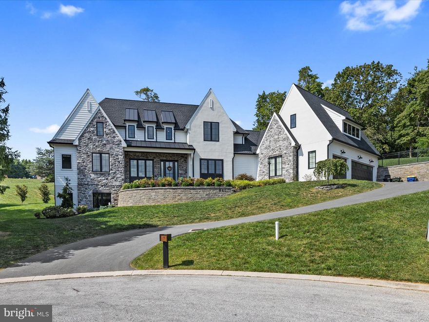 Nestled in the exclusive Wyndham Hills, this residence awaits its new owners. This home was custom-built by Merv Miller Builder, no detail was overlooked in the creation of this unparalleled estate. Upon arrival, one is immediately struck by the home’s commanding position atop the neighborhood, offering sweeping vistas of the meticulously landscaped grounds below. Upon entry, a two-story foyer greets you with rich hardwood floors, elegant crown molding, and tall ceilings. The open concept living area, highlighted by a stately fireplace, is perfect for refined entertaining. This expansive home caters to every desire, with five generously proportioned bedrooms, four full baths, two offices, and an exercise room. The main level showcases a gourmet kitchen that epitomizes luxury, complete with a Monogram stainless steel six-burner range, dishwasher, refrigerator, central island, and a walk-in pantry. Custom cabinetry provides ample storage, while a dry bar with a beverage cooler enhances the space’s functionality. The primary suite, an oasis of tranquility, boasts vaulted ceilings, exposed beams, and two opulent walk-in closets. The spa-inspired en-suite bathroom features dual vanities, a walk-in shower, a private water closet, and a soaking tub. The main level also includes a spacious office with serene views of the rear yard and an additional bedroom with its own en-suite bath. Upstairs, the loft area offers versatile space for relaxation and storage, accompanied by two spacious bedrooms, each with walk-in closets, and a luxurious Jack and Jill bathroom featuring two vanities. The lower level is designed for leisure and entertainment, with a generous recreation room, a wet bar with a beverage cooler, abundant storage cabinetry, an exercise room, a second office with French doors, and another bedroom with a full bath. The exterior of the home features a charming patio with a built in gas grill and cabinetry, perfect for enjoying the surrounding natural beauty. Do not miss the opportunity to own this extraordinary residence—arrange your private showing today.