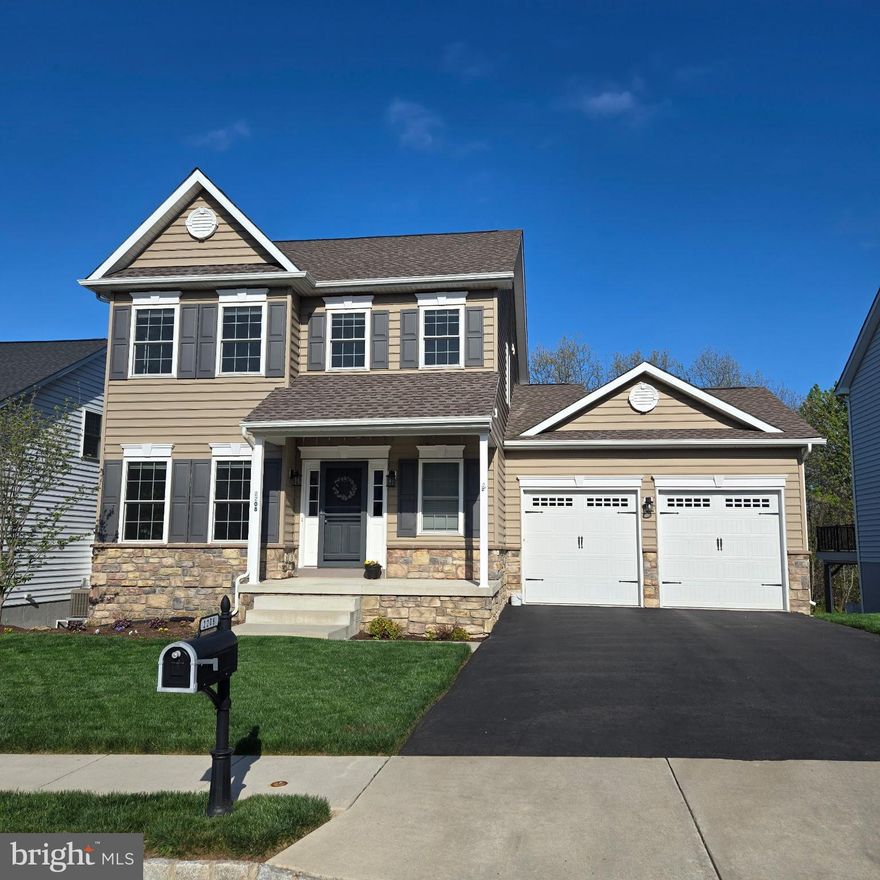 Welcome to 2208 Bridgeport Ave in the Northgate community in Pennsburg. This well maintained 3 bedroom, 2.5 bathroom colonial, built in 2019, offers space, character, and thoughtful upgrades selected by the original owners. Step inside to a warm and inviting layout featuring detailed wainscoting that adds charm and a finished touch. Just off the entry is a private office that can easily function as a flex space or potential first floor bedroom and a powder room just across the hall. The main living space opens beautifully between the dining area, living room, and kitchen, creating a comfortable setting for both everyday living and entertaining. The living room is anchored by a gas fireplace, adding warmth and a cozy focal point. The kitchen is well appointed with a center island, granite countertops, stainless steel appliances, and propane gas cooking. Just beyond, a first-floor laundry and mudroom offer added storage and convenience, along with access to the expanded two car garage with parking for two vehicles plus additional storage and workspace. Off the living room, step out to  a large deck featuring both screened in and open-air sections, perfect for relaxing or hosting in any season. The backyard backs to a wooded area and includes space for gardening. A paver patio sits below the deck, accessible from the walkout basement. Upstairs, you will find three generously sized bedrooms, including a primary suite with a walk in closet and private en-suite bathroom. A hall bathroom completes this level. The finished walkout basement adds valuable living space, ideal for a family room, gym, office, or guest area, along with built in storage and a dedicated workshop space.  The Northgate community, located in Montgomery County offers open green space, walking trails, and outdoor recreation areas, all while being conveniently close to local amenities and major routes. This home delivers a well-balanced combination of comfort, flexibility, and setting.  Make your appointment today.
