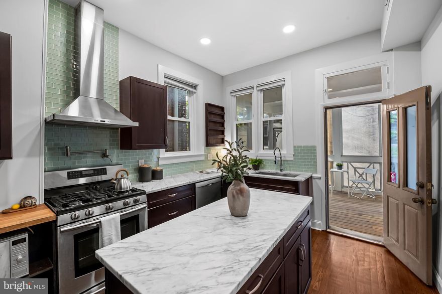 This expansive 3 bedroom PLUS an office/den row home in Butcher's Hill blends historic character with modern style, featuring soaring ceilings, a rare SCREENED-IN PORCH off the kitchen, and a two-level ROOFTOP DECK with sweeping views of the city and harbor. The main level feels open and inviting, with a spacious living room showcasing original details, a dining room anchored by a custom built-in bar, a convenient powder room, and a gourmet marble-topped kitchen with an island and plenty of storage. Upstairs, you’ll find two generous bedrooms and a full bath, including a rear suite PLUS a cozy office/den or nursery complete with built-ins. The top floor is dedicated to the primary suite adorned with exposed beam details in the bedroom, a large bath featuring a clawfoot tub and direct access to the rooftop deck from the hallway. A walkout basement adds great storage. This home is a rare find that delivers space, classic yet modern finishings, and unbeatable outdoor living in one of Baltimore’s most sought-after neighborhoods. Seller updates include: Roof deck, Screened in porch, Refrigerator, Dishwasher (all in 2020). Baseboard heat is not operational/no longer needed. Home is heated/cooled via central air and ductless units for the 3rd level. Washer/dryer can likely be relocated to 3rd level across from bathroom since there is plumbing behind access panel.