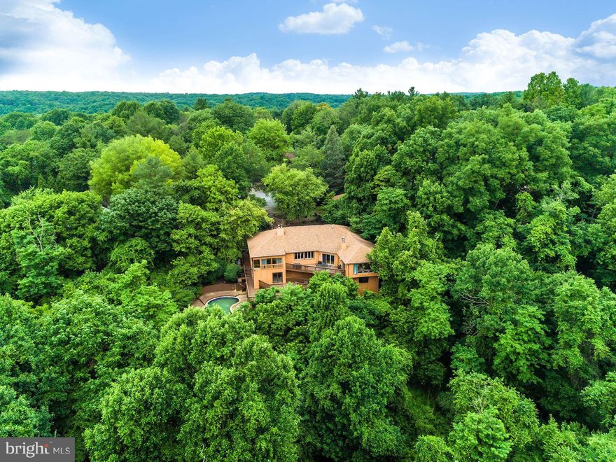 Stunning Contemporary! Over 7,900 Sqft. & 0.77 Acres of Private Serene Land w/Pool, Multiple Decks, Landscaped Grounds & AMAZING VIEWS! Lofty Windows, Skylights, HW Flrs, 4 Fireplaces & Light Filled Interiors! Eat-In Kitchen w/SS Appliances &Granite. Sunken LR & Separate DR. ML Master w/FB & Huge Walk-In Closet. LL w/ Rec Rm, Wine Rm, 2nd Kitchen, 3 BR s, Wet Bar, Game Rm &FB; Ideal In-Law Suite!