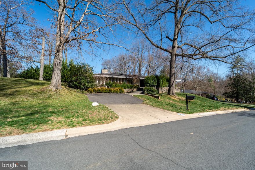 Light-Filled Mid-Century Modern Home in Bannockburn Estates, Bethesda. Discover this beautiful 5-bedroom, 4.5-bathroom mid-century modern home, offering 4,498 finished square feet of bright, elegant living space. Nestled on a private 0.53-acre lot, this home boasts an open floor plan with seamless indoor-outdoor flow. Home is in a prime location, situated minutes from the C&O Canal, with easy access to hiking trails and the scenic Potomac river and convenient commuting options to Washington, D.C. and Virginia via Clara Barton Parkway, MacArthur Blvd, Mass Ave, GW Parkway and I495. Close to bus routes to the Metro and downtown Bethesda’s vibrant shops and restaurants. Features stunning outdoor spaces with a fully fenced, private backyard surrounded by mature pine trees, an expansive stone patio—suitable for entertaining or relaxing, floor-to-ceiling glass doors in the living and dining rooms, bringing the outdoors in. Beautifully updated interior with an updated kitchen featuring an induction stove, new GE Profile double oven, GE Profile refrigerator, and Bosch dishwasher. Luxurious primary suite & updated baths. Laundry/mudroom with a large-capacity washer and dryer, fully finished walkout lower level with a large bedroom & full bath, bar area, spacious living & workout area and ample storage. This exceptional home offers a balance of privacy, convenience, and modern elegance.
