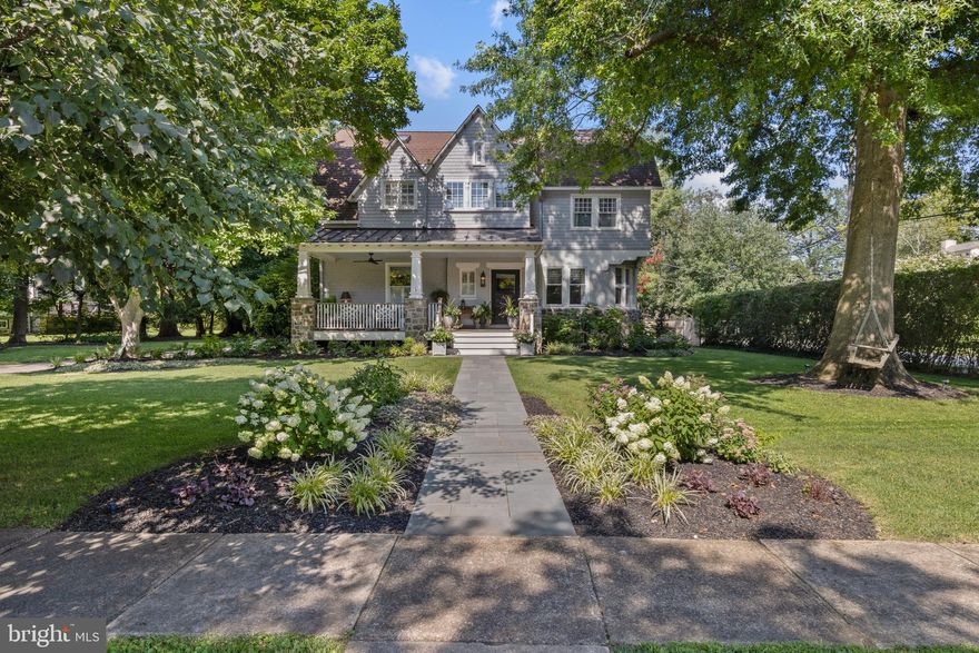 Welcome to 401 Chestnut Lane, a beautifully renovated home that blends timeless charm with thoughtful modern updates.  Nestled in the enchanting community of North Wayne, this “walk to Wayne” historic gem graces one of North Wayne’s most desirable corner lots with a sizable flat yard and beautiful mature trees and landscaping. With 7 bedrooms and 5 baths, this home is ideal for those seeking a vibrant, family-friendly neighborhood filled with year-round events like progressive dinners, bookclubs, parades, holiday celebrations, and more. North Wayne offers a storybook setting, with tree-lined sidewalks, and is a short stroll into the lovely town of Wayne with its award-winning restaurants, coffee shops, bars, independent stores, and the Wayne train station with direct service into Philadelphia and beyond. Nearby amenities also include the Wayne Library, post office, Radnor Middle School, Lancaster County farmer’s market, several colleges and universities, grocery stores, banks and medical facilities. Several parks and playgrounds are a short walk or bike ride away and even a neighborhood pond for fishing in the summer and ice skating and sledding in the winter!  Built by Wendell and Smith in 1895, the "Round End House" design showcases curved leaded glass windows, uniquely carved newel posts and spindles, and detailed millwork. An inviting deep front porch with gorgeous stone pillars, a wide staircase, and a ceiling fan overlooks the beautifully landscaped front lawn, and is the perfect perch year-round. The lush surroundings, filled with mature trees and blooming flowers, provide a serene backdrop for relaxation and entertainment. Inside, you are welcomed into the oversized entry foyer with its charming original architectural details. The large living room beckons with its stunning curved windows, handsome custom millwork and built-ins surrounding the fireplace, which has been conveniently converted to gas. To the other side of the entry hall is a room with a half bath and glass doors that is ideal for a home office or a child’s playroom. Further down is another room with sliding pocket doors to the kitchen that can serve as a cozy family room or dining room. At the rear of the house is the spacious bright kitchen which boasts an abundance of windows providing natural light throughout the day, plenty of cabinets and storage, high-end appliances including a Viking dual-fuel range, a JennAir wall oven and microwave, and two JennAir integrated refrigerated drawers. The oversized center island features a large sink, Bosch dishwasher, and has seating area for at least four stools. The island and all cabinetry is complemented by striking Carrara marble countertops. A convenient wet bar area is nearby with a beverage cooler, ice maker and handsome leathered granite top. The breakfast room’s wall of glass opens onto a delightful deck and stone patio, perfect for morning coffee or evening gatherings. The luxurious primary suite offers windows on all sides, an oversized walk-in closet as well as two additional mirrored closets, and an elegant spa-like bath featuring two separate vanities, radiant heated floors, a soaking tub, towel warmer, and an expansive shower with double rain heads. All bedrooms have ample closets. Handsomely updated hall baths are on the second and third floors.  Additional features include a convenient second floor laundry, a main floor mudroom with built-ins and half-bath, an 800 sq ft finished lower level boasting a cozy sitting area with a built-in electric fireplace, as well as a large playroom, a Brunswick pool table, loads of storage, and charming historic details throughout. Outdoors, you will appreciate the stone patio, a side porch with outside potting sink, a partly fenced yard, an electric fence for pets, and a 4-car parking area equipped with an EV charger hookup.