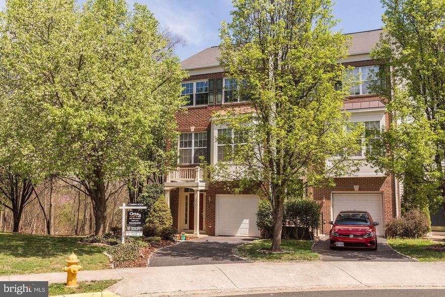 Ready to move on June 11th. Stunning End Unit Brick front Townhome that features almost 2,200 Sq ft that backs to thick woods with no thru street.  3 Bedrooms with 3 Full and One-half Bathrooms. Open concept kitchen with a huge family room that features Quartz Countertops, Huge Center Island, Stainless Steel Appliances, White Cabinets, Hardwood floors, and ample natural light. Finished walk-out lower level with Newer Laminate floors on the entire lower level, full bath, and walk-to flat backyard. Updated bathrooms and Upgraded tile in baths.  Patriot School District. Walk to Cedar Elementary School. Must See!