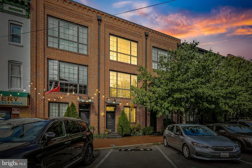 Rarely available Merchant Point Row Home in Upper Fells Point! Live only steps away from Johns Hopkins hospital, the waterfront and charming shops and awesome restaurants in the historic Fells Point neighborhood. This unique urban home features 4 levels of luxury living, wired for surround sound throughout. The home is perfect for entertaining, starting with the entry level 2 car tandem garage, which doubles as an entertainment space, including custom cabinets, an upgraded floor and tons of storage.  The rest of the first floor includes a full bath and bedroom with custom built-in bookshelves, perfect for working from home. The 2nd floor boasts a phenomenal living room with a large slider leading out to a deck where you can grill and eat out or relax with a book. There is a gorgeous 20 by 15 living room and separate dining area. The gourmet kitchen offers a beer/wine frig., built in wine storage rack, Caesarstone counters, massive island, and plenty of storage in the large pantries. On the 3rd floor is the primary bedroom featuring a luxurious en-suite bath with built in storage. There is a second bedroom with floor to ceiling windows, a full bath in the hall, and W/ D closet. The top floor offers an additional family room leading to a truly spectacular 15 by 15 deck with pergola shade and built in seating, offering beautiful views of the city. You have to see this oasis in person to truly appreciate it! My favorite elements of the home include the open steel staircase, 4 inch oak floors through-out, the sleek red brick façade and 10 foot ceilings. This one won't last long.