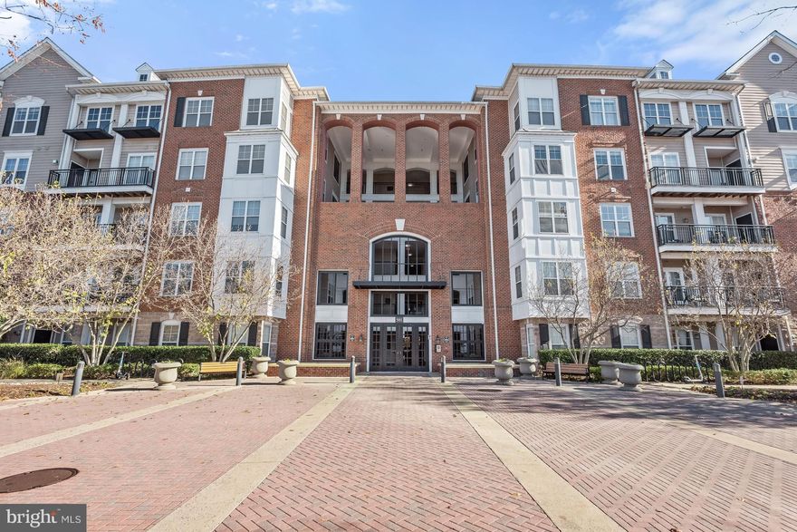 Beautiful garden level condominium located in the amenity rich Fitz at Rockville Town Center.  This home comes with a 1-car garage and in home storage room and boasts a sun filled open floor plan with hardwood flooring and a soothing color palette throughout. The kitchen features stylish black granite countertops and white cabinetry,  and stainless appliances that include a gas cooktop.   A custom-built dry bar with a matching granite top is highlighted in the dining area and the living room has a 3-panel atrium door providing abundant natural light and access to the patio.    Retire to the spacious bedroom that includes a large walk-in closet and an en suite bath.  Enjoy a cup of brew on your own private patio with poolside views and all the many amenities this community offers that include a swimming pool, fitness room, mini theater, a great room, billiard room, kitchenette and more.   Conveniently located near the metro and MARC train, Rockville Town Center for shopping, dining, and entertainment options and next to your local grocery store.
