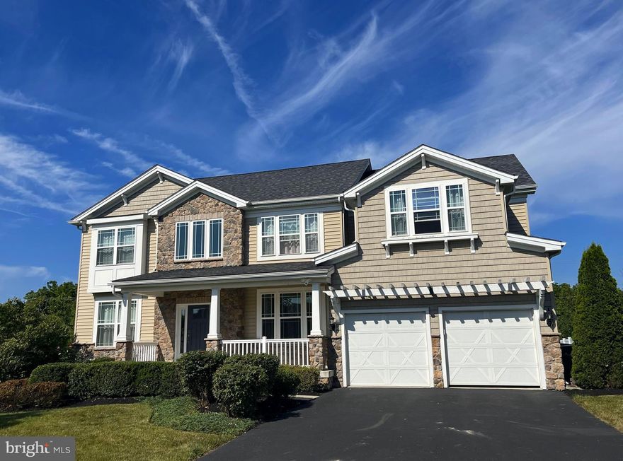 Welcome to this gorgeous five-bedroom home exuding elegance and style!   It is  located in the prestigious Maple Brook Estates—a secluded enclave of 19 stunning homes. This dream home features a masterfully designed unique floor plan, exceptional custom appointments and tasteful decor.  An inviting front porch immediately draws you in to see more. Upon entering, you are greeted by the dramatic two-story foyer with double bull-nosed flanks on the turned wooden staircase, setting the stage for the luxury  that lies ahead. The formal living room with a double window overlooks the manicured open common ground across from the home.   Gleaming hardwood floors begin in the foyer and continue into the ample-sized formal dining room, perfect for special dinners.  The spectacular kitchen features beautiful hardwood floors, a huge center island as the focal point for large gatherings, a built-in wall microwave and oven,  gas cooking with external venting,  beautiful granite counters,  ceramic tiled backsplash, a roomy double pantry, and upgraded 42-inch cabinets. Stainless steel appliances complete this exquisite chef's  kitchen.  The spacious extended breakfast room with a slider opens to the fenced-in backyard. This lovely  fenced back yard boasts an expansive paver stone patio with a wall border, overlooking a level garden  sanctuary with a treed view—perfect for hosting friends and family.  The kitchen opens seamlessly into the family room,  featuring a dramatic 10-foot ceiling with crown moldings and a cozy gas fireplace. Tucked in next to the familyroom,  is a first-floor bedroom  and an adjacent sparkling full bath with a transom window,  ideal for guests or as a convenient in-law suite.  A handy laundry room with a counter, cabinets and a family coat closet near the 2-car garage with extra storage, complete the first floor. The T staircase leads to the second floor, where a wide hallway with hardwood floors with double doors opens to a beautiful primary suite. This suite includes a sitting room, enormous double walk-in closets, custom tile, double sinks spanning a huge vanity, a spa soaking tub, and a separate toilet area. Two  ample sized bedrooms border the hall bath, and the fifth large bedroom has its own walk-in closet.  But then , there is a surprise!  At the center of the second floor is a wonderful bonus room/playroom with endless possibilities. Wow! There is more!  The amazing finished basement features luxury vinyl flooring and is thoughtfully laid out with a theatre area, bar area with a custom wine rack and mini fridge, and a sitting /game room area. This smart layout provides ample space for relaxation and entertainment.  There is still plenty of storage in the unfinished portion of the basement, complete with built-in storage shelving and a workbench. Recessed Lighting is  purposefully placed throughout the home, enhancing the ambiance and functionality of each space.   Located within the sought-after North Penn School District, this home is close to parks, shopping, and all major conveniences. This home encompasses all the luxuries you could dream of and is not to be missed! Interior photos coming by Thursday !