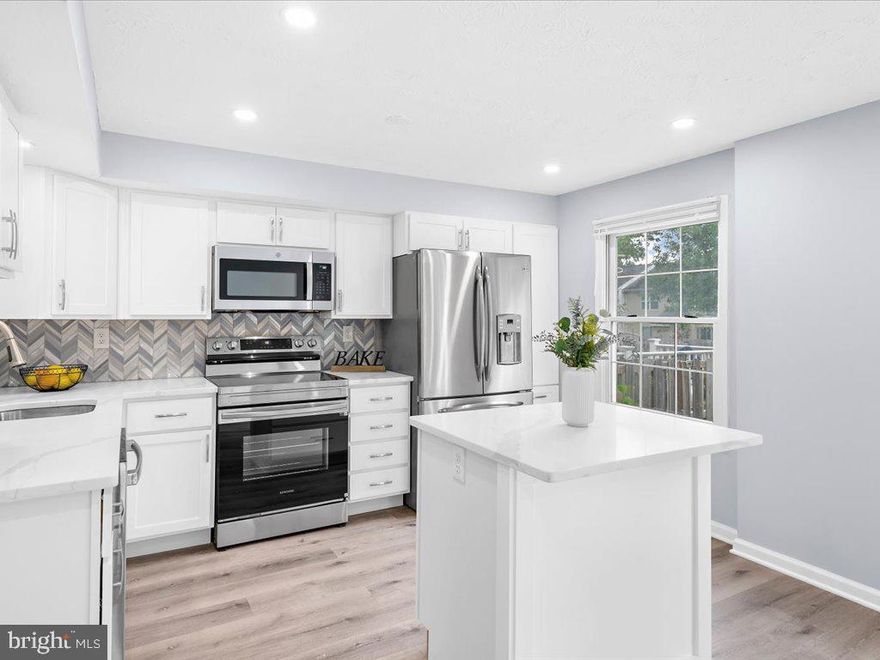 With three finished levels and more than 1,800 square feet, this beautifully renovated end-unit townhome is an entertainer’s delight. As you enter the home, you are greeted by the cleverly designed “welcome center,” a perfect spot to hang your hat and drop your bags. The main level’s open floor plan showcases the home’s primary living area, including a living/dining room and kitchen as well as a half bath and an open staircase to the upper and lower levels. The living room is a large, flexible space that can be used as one large living space or separated into a living and dining room. Designed for both cooking and gathering, the kitchen has a large island with breakfast bar, white shaker style cabinets, quartz counters, a chevron-patterned tile backsplash, stainless steel appliances, a dedicated pantry, and a large, casual dining area. Three bedrooms and two full baths comprise the upper level. You will love the primary bedroom with an ensuite bathroom and a closet with unique built-in shelving. The primary bathroom has a tiled shower with a lighted niche and sliding glass barn doors. A second large full bathroom has a tub with a tiled shower surround and niche as well as a spacious linen closet. A large family room and half bath are in the finished lower level. This level also has a large unfinished utility/laundry room with plenty of room for storage. An open staircase with a modern finish and upgraded metal balusters connects the three levels. For outdoor living, a large deck with steps to the back yard can be accessed from the dining room. Additional renovations include new luxury vinyl plank flooring and carpet, new recessed lighting and light fixtures, bath and plumbing fixtures, fresh paint throughout, and much more! For added convenience, there are two assigned parking spots in front of the house as well as visitor parking. Convenient to UMBC, CCBC, the Arbutus Library, Patapsco State Park, Arbutus Memorial Park, and BWI Airport, as well as major commuting routes, including I-95 and 295. This home has it all! Welcome home.