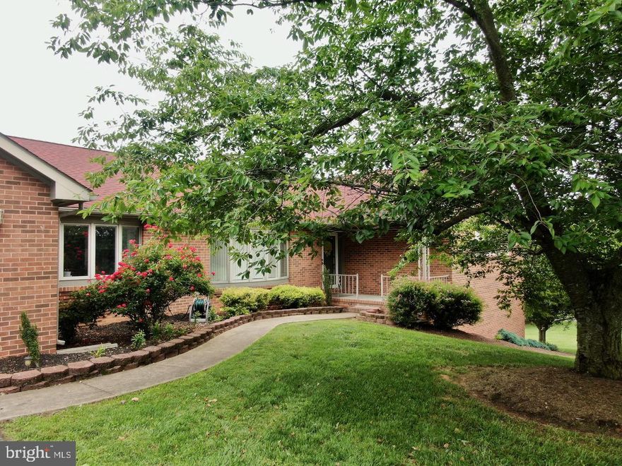 Gorgeous all-brick rambler situated on a park-like 1.8 acre lot in Winfield - convenient to everything  Martinsburg has to offer but feels like country living.  You'll love the gleaming hardwood flooring in the main living area. As you enter the front door, the main floor features a large living room and bright dining room. From here you'll enter the spacious family room with an attractive brick fireplace and adjoining 4 seasons sun room with a view of the spacious deck.  The kitchen and eat-in dining area adjoin the family room. The kitchen offers Silestone countertops, an newly installed refrigerator and double wall ovens.  from the kitchen, you'll find a convenient pantry, laundry and half bath, plus access to the oversize deck and heated Endless Pool. Also on this floor you'll find your spacious master suite with a full bathroom featuring a soaking tub and shower. Two other roomy bedrooms and a full hall bathroom provide plenty of options.  There's more amenities downstairs with a fully finished rec room, 4th bedroom and another full bath.  Recent updates include architectural shingle roof (2013), new HVAC system (2021), new toilets  and refrigerator (2022), For convenience, the home has a central Vac system. In the yard you'll find peace and tranquility with flowering plants and mature fruit trees. Come meet your future getaway just minutes from town!
