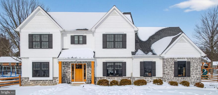 Only six years young, this exquisitely designed, custom-built home has been meticulously maintained by one family.  Better than building:  It presents Like New on a large, deep lot offering privacy in a convenient location.  With custom-crafted finishes and  attention to detail throughout, this stunner is set in Lititz, one of Lancaster County’s most sought-after towns.

This impressive 4-bedroom, 3.5-bath residence currently offers more than 3,000 sqft of beautifully designed living space — with an additional 1,690+ sqft available in its unfinished lower level = over 4,700 sqft of potential.  Lower level features higher ceilings, 4 additional casement windows and an egress already in place.  This impressive home rests on a breathtaking 1.63-acre setting, thoughtfully crafted to elevate both everyday living and elegant entertaining. Too many features and upgrades to list, a tour is recommended.

From the moment you arrive, the home’s striking façade commands attention. Classic white siding is beautifully paired with stone accents and contrasting black windows and shutters, creating a stately yet inviting presence. The covered entry with rich wood posts and front door set the tone for the refined interiors that await.

Inside, you’re greeted by high ceilings and the light-filled. open-concept layout designed for both everyday living and entertaining atop noble wood floors. The heart of the home is the stunning chef's kitchen, featuring crisp white cabinetry, sleek quartz countertops, SS appliances, walk-in pantry and two-tier center island with seating for four.  A coffee bar/beverage center with a secondary prep sink makes entertaining effortless.  Pendant lighting and recessed lights keep the space bright and inviting, while the wide plank wood floors add warmth and continuity throughout the main living areas. The large kitchen flows seamlessly into the casual dining space—ideal for meals overlooking the fenced backyard.  

The adjacent dining room flows gracefully from the kitchen, offering an elegant setting for intimate dinners or larger celebrations. Behind glass French doors, you'll find a home office or library. Every detail has been curated to elevate the living experience while maintaining a sense of effortless comfort.

The bathrooms are equally impressive, delivering a spa-inspired retreats within your own home. A freestanding soaking tub, glass-enclosed walk-in shower adorned with white custom tiles and modern dual-sink vanity highlights the primary suite.  A Jack & Jill bathroom connects two additional bedrooms with ease.  Guests will appreciate another bedroom with private ensuite bath.  

Throughout the home, thoughtful details shine—from updated fixtures and finishes to a layout that feels both functional and refined. Every space is designed to feel open, airy, and move-in ready.  Outdoors the possibilities flow. When building, stormwater management was upgraded to provide for more impervious surface, such as 1,000 sq ft for pool or hardscaping - confirm exact amount with township.

Ideally located, this home offers the rare combination of upscale living with convenient access to local boutiques, dining, parks and top-rated schools—all within a peaceful residential setting just minutes from downtown Lititz and Lancaster.

Built by Hess Home Builders, 103 E Woods Dr is an exceptional opportunity to own a distinguished home in pristine condition without the timing or small lots of most new construction.  Peace of mind is provided by two HVAC zones with air scrubber UV, tankless water heater with water filtration and softener systems and radon mitigation system.  Please view the video and floorplans included here.  This remarkable residence is ready to welcome its next chapter — contact us for a private showing to experience all it has to offer.