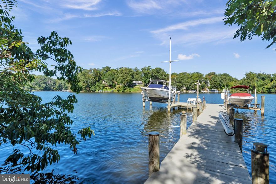 Nestled in the prestigious Admiral Heights community, this exquisite Craftsman-style residence has undergone a remarkable transformation, with major renovations completed in 2011 that elevate its charm and functionality. Spanning an impressive 3,900 square feet, this home seamlessly blends luxury with comfort, offering an exclusive lifestyle that is both inviting and sophisticated. As you step inside, you are greeted by a warm ambiance that flows throughout the open-concept living spaces. The heart of the home features two elegant fireplaces, perfect for cozy evenings spent with loved ones. The thoughtful design ensures that every corner of this residence is bathed in natural light, enhancing the inviting atmosphere. The property boasts four spacious bedrooms and four full bathrooms, providing ample space for relaxation and privacy. Each room is designed with high-end finishes and meticulous attention to detail, ensuring a serene retreat for all who enter. One of the standout features of this home is its breathtaking views. Enjoy picturesque scenes of Weems Creek and the surrounding scenic vistas from multiple vantage points. The outdoor space is equally impressive, with a private dock site that offers direct access to the water, perfect for boating enthusiasts or those who simply wish to unwind by the water's edge. The dock is equipped with a 10,000 lb and 20,000 lb electric hoist/lift and plenty of space for docking, making it a true gem for water lovers. The community amenities include a refreshing pool with a pool membership, providing a perfect escape during warm summer days. The lush, landscaped lot spans 0.24 acres, offering a tranquil setting that harmonizes with the natural beauty of the area. Parking is a breeze with an attached garage, a detached garage, and ample driveway space, accommodating multiple vehicles with ease. This home is not just a residence; it is a lifestyle choice that embodies luxury, comfort, and the joys of waterfront living. Experience the perfect blend of modern amenities and timeless elegance in this stunning property, where every detail has been thoughtfully curated to create a haven you will be proud to call home. Brand new washer, dryer ,wall oven and wall microwave. In addition, the two HVAC units are both just 3 years old!