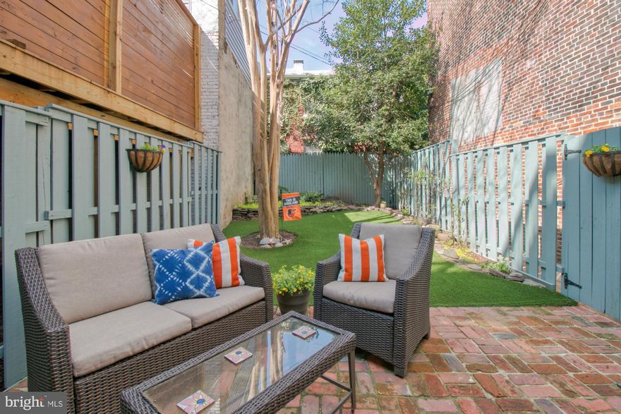 Welcome to your city oasis. This  20 ft. wide townhouse has plenty of room to live, work and play. Enjoy four sun filled levels with an open and modern design. The main living level is on the second floor with the large kitchen and inviting living room, half bath, laundry and a door leading to the deck and expansive back yard. Ascend to the third floor with two large bedrooms and a full bath with jetted tub/shower combo and double vanities. The fourth floor primary bedroom suite has vaulted ceilings, five deep closets, charming dormered windows and a skylight in the ensuite bath with standing shower. The first floor entry provides a flex space for a family room, dining room, workout space or office, with a half bath and walk out to the patio and landscaped back yard. Custom built-ins, hardwood floors and shutters can be found throughout the home. Prepaid parking is just steps from the front door and is an assigned parking spot. With the Homestead tax credit (owner occupied), annual taxes are $7,573.64.