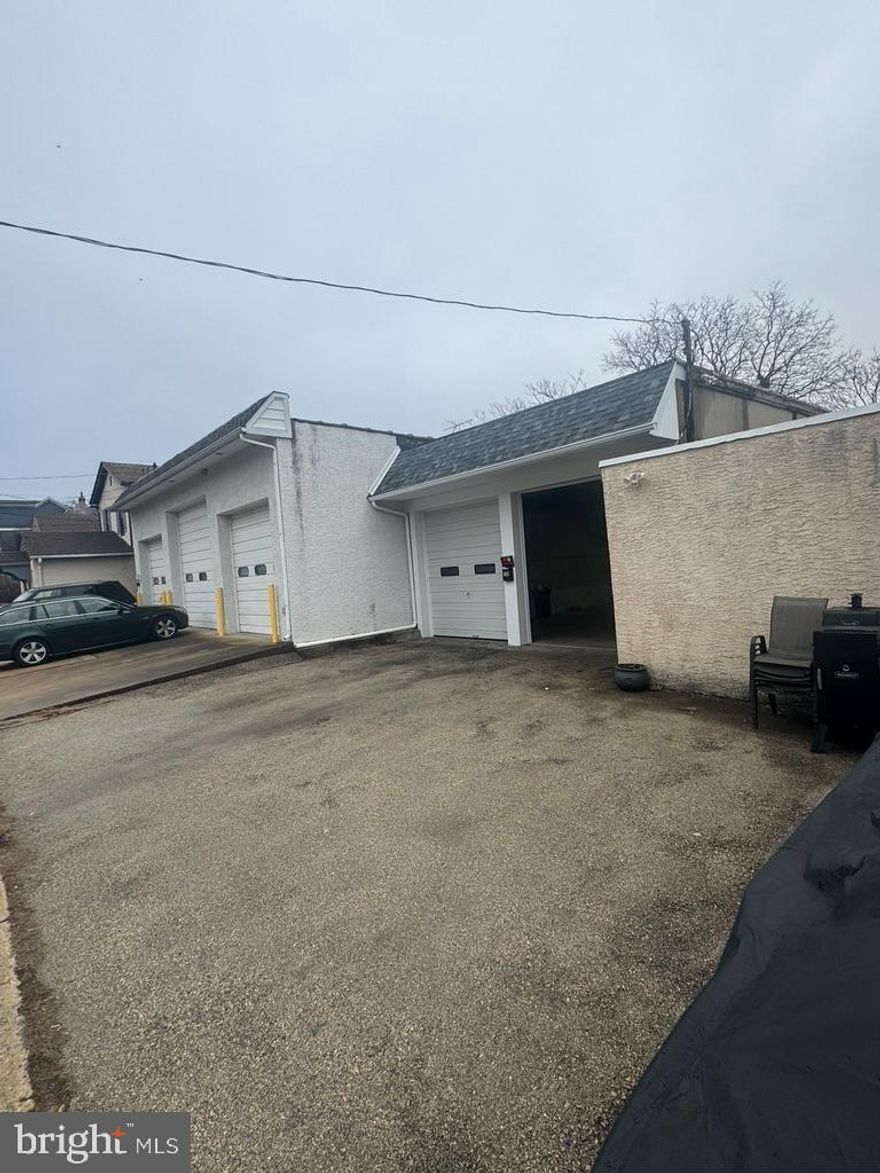 4 car garage FOR RENT, along with 1 room office space (room to the right once you enter into garage), 2 parking spaces out front, and a yard out back behind garage (door from garage leading out back to yard). Mailbox at the garages says 709 Spring Mill. 

Garage includes two garage doors at the front & fits at least 4 cars inside. The previous use for this space was a car detailer (specific use would have to be run by the township). There is a tenant in the building connected to the garage. This garage would share electric with the rest of the building (with the tenant).