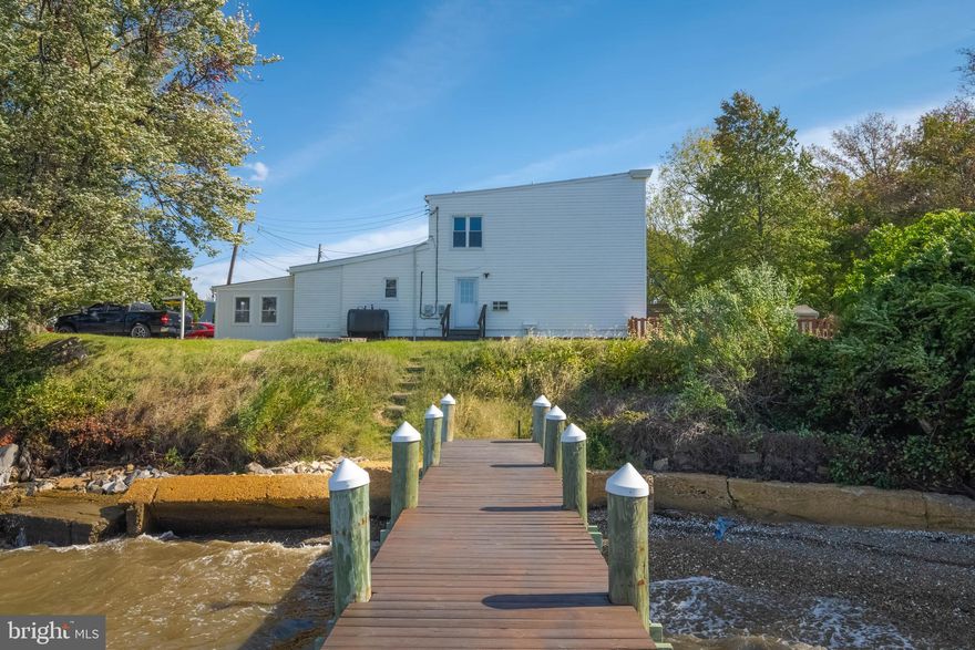 Charm meets convenience with this semi-detached waterfront home! 110'+ of water frontage with a 90' pier built in 2016. The pier boasts a 10'x10' platform, an aluminum high speed 10k boat lift, and second aluminum single piling boat lift as well. This home sits elevated off the water, and is not in a flood zone (buyer to verify) . This home offers 2 bed/1 full bath, with room to add an additional bedroom/bath. Top notch Sparrows Point school zone, and many amenities just a stone's throw away. Your dream home awaits!